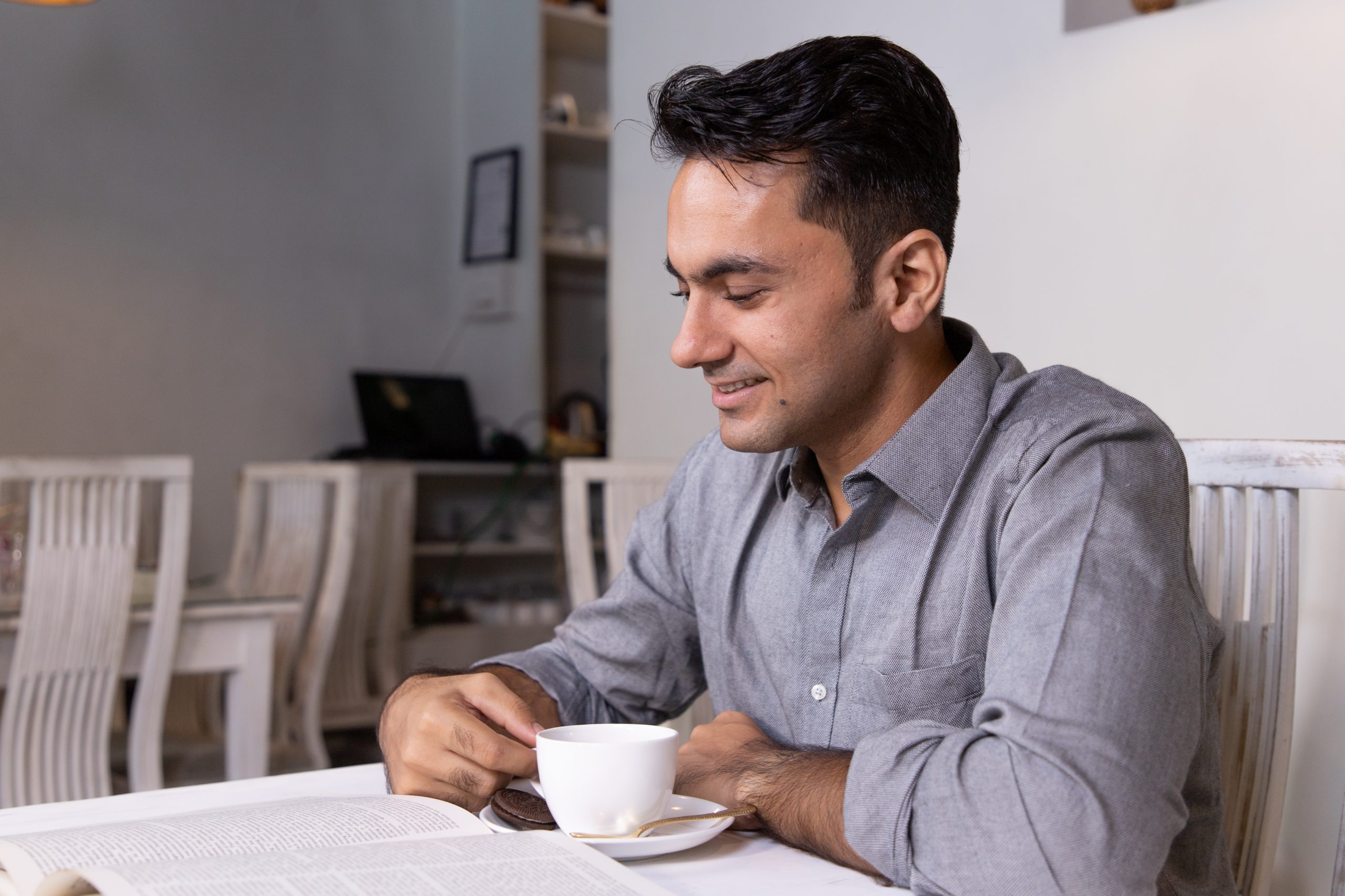 A man reading book in cafe