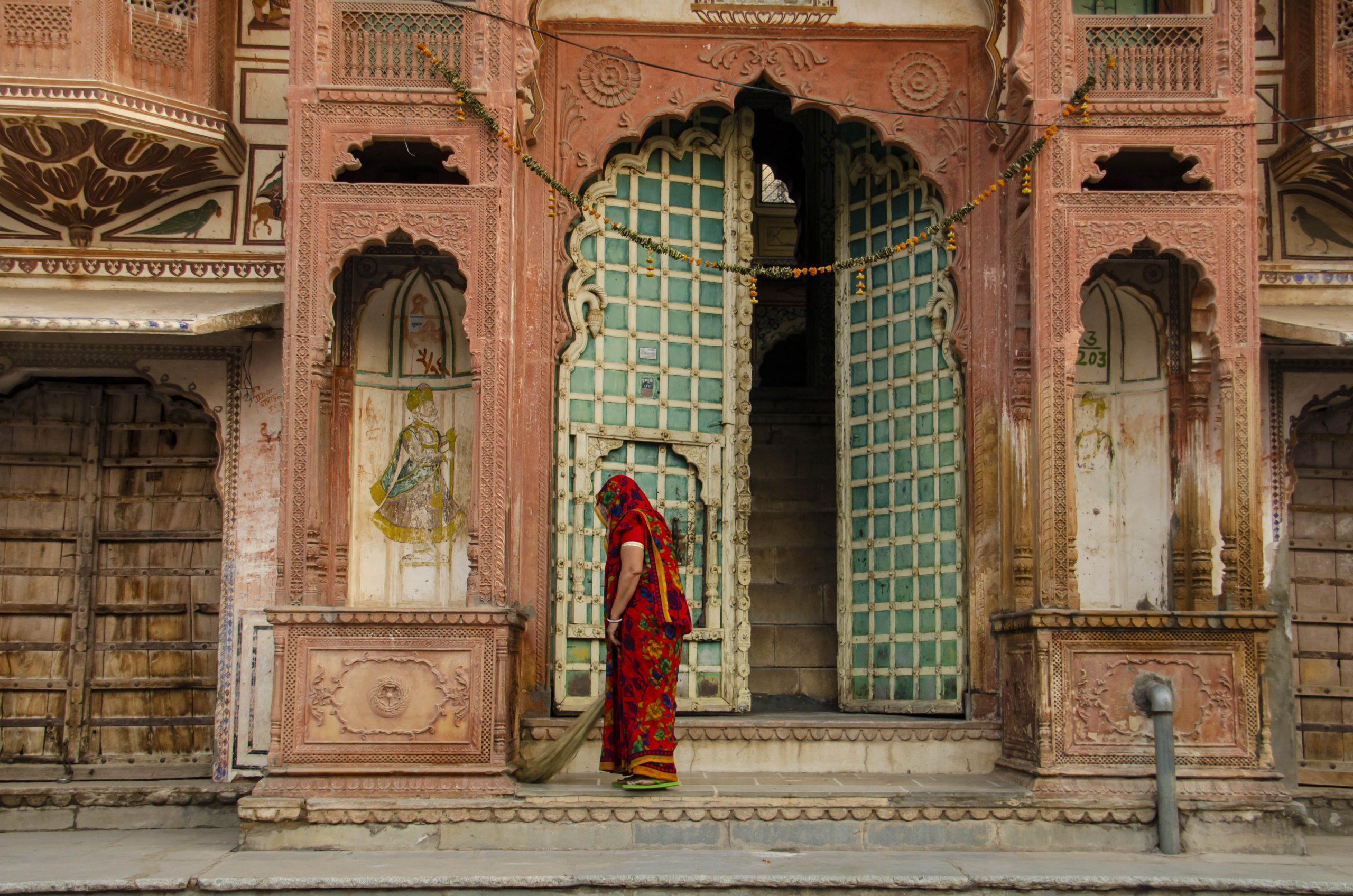 A woman sweeping a temple door