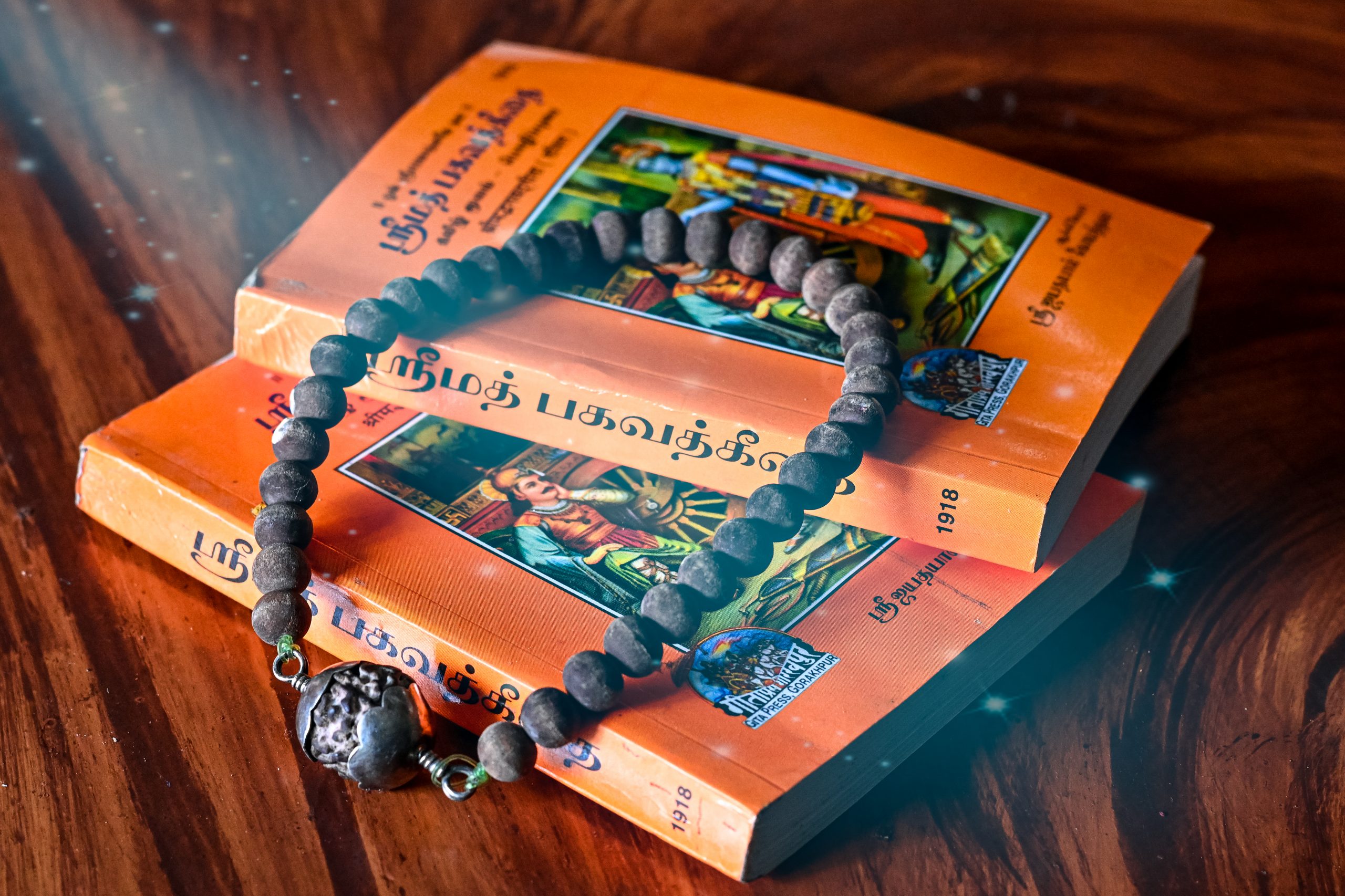 An old bead necklace on a sacred books