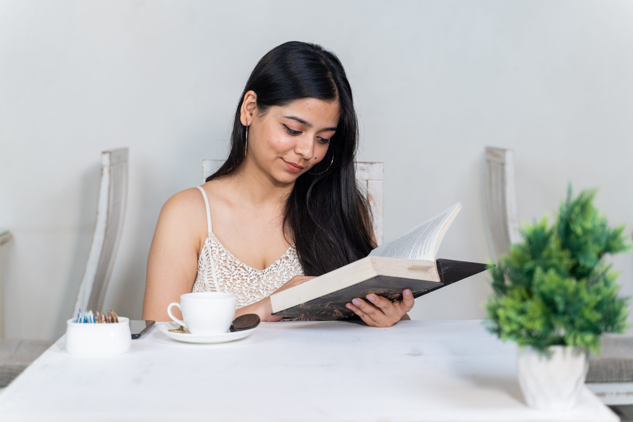 girl reading a book in a restaurant