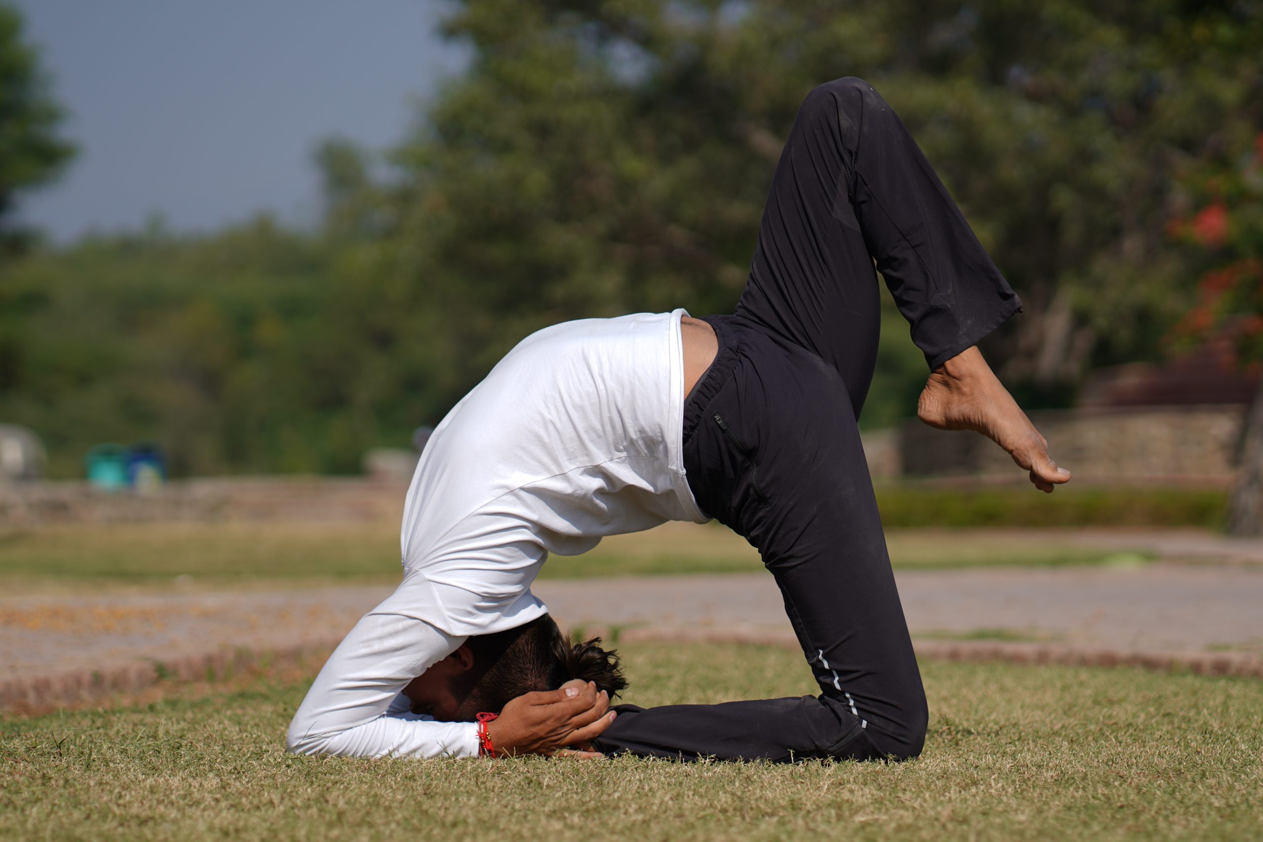 man doing yoga in garden