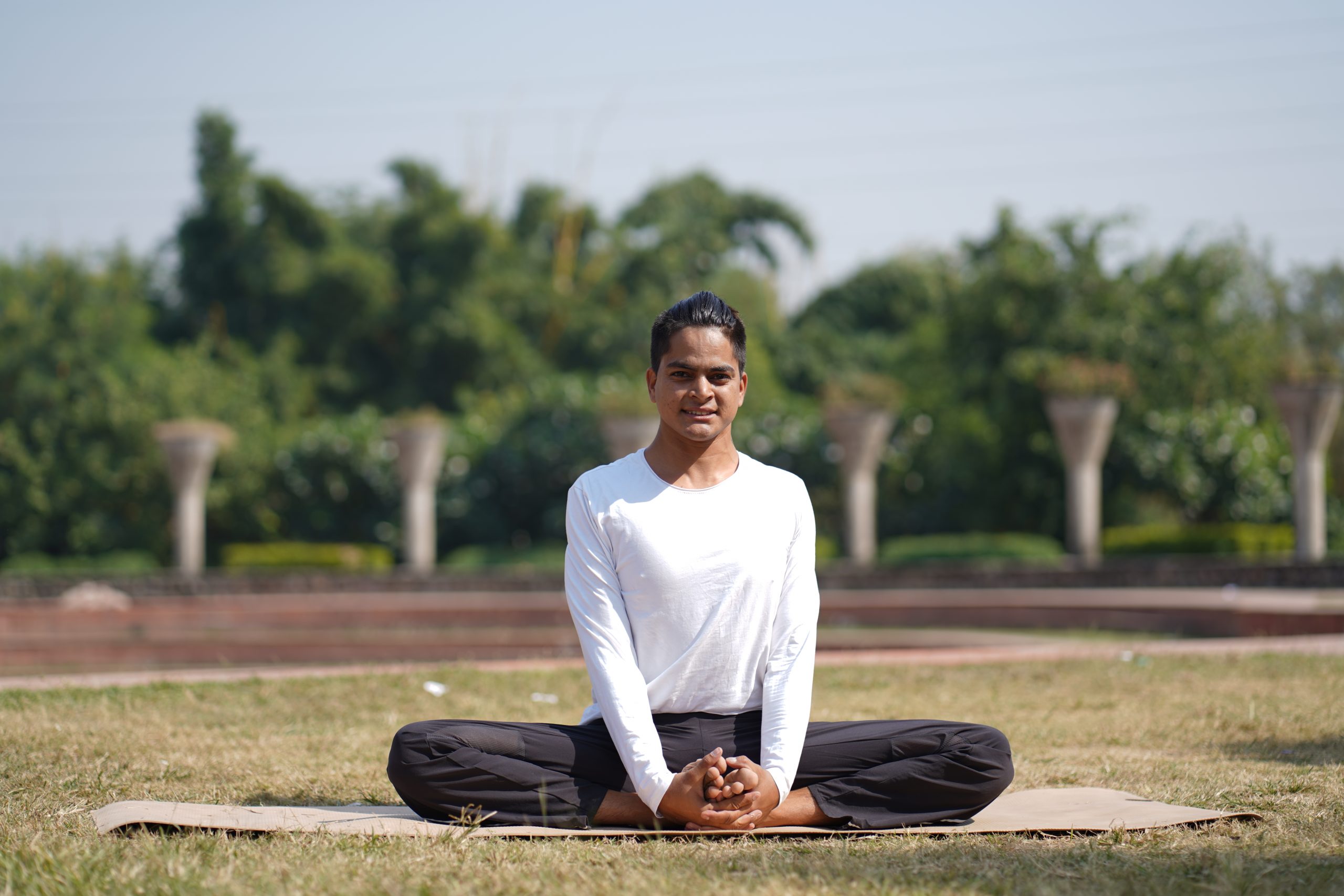 man doing yoga in garden