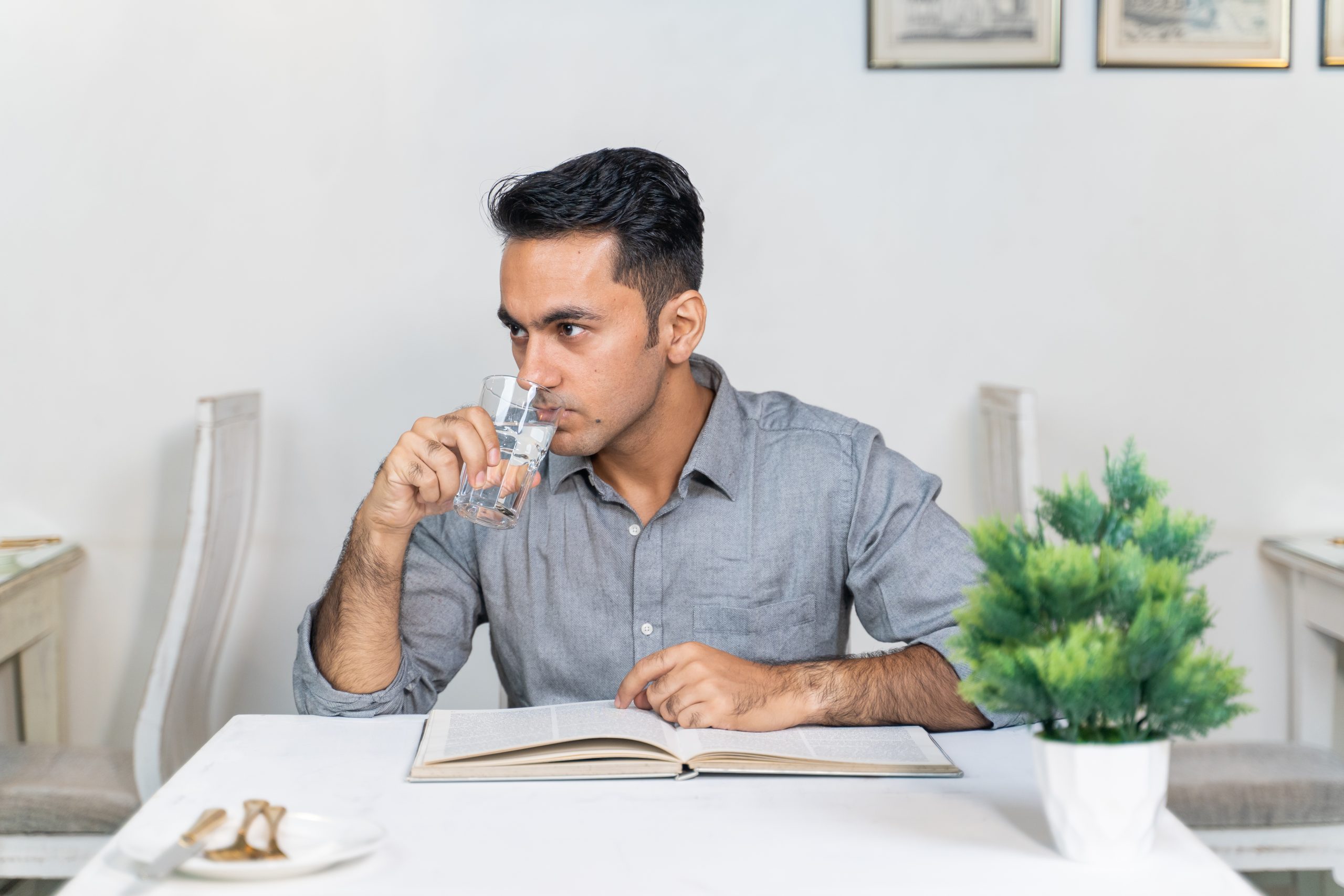 Boy drinking water in restaurant