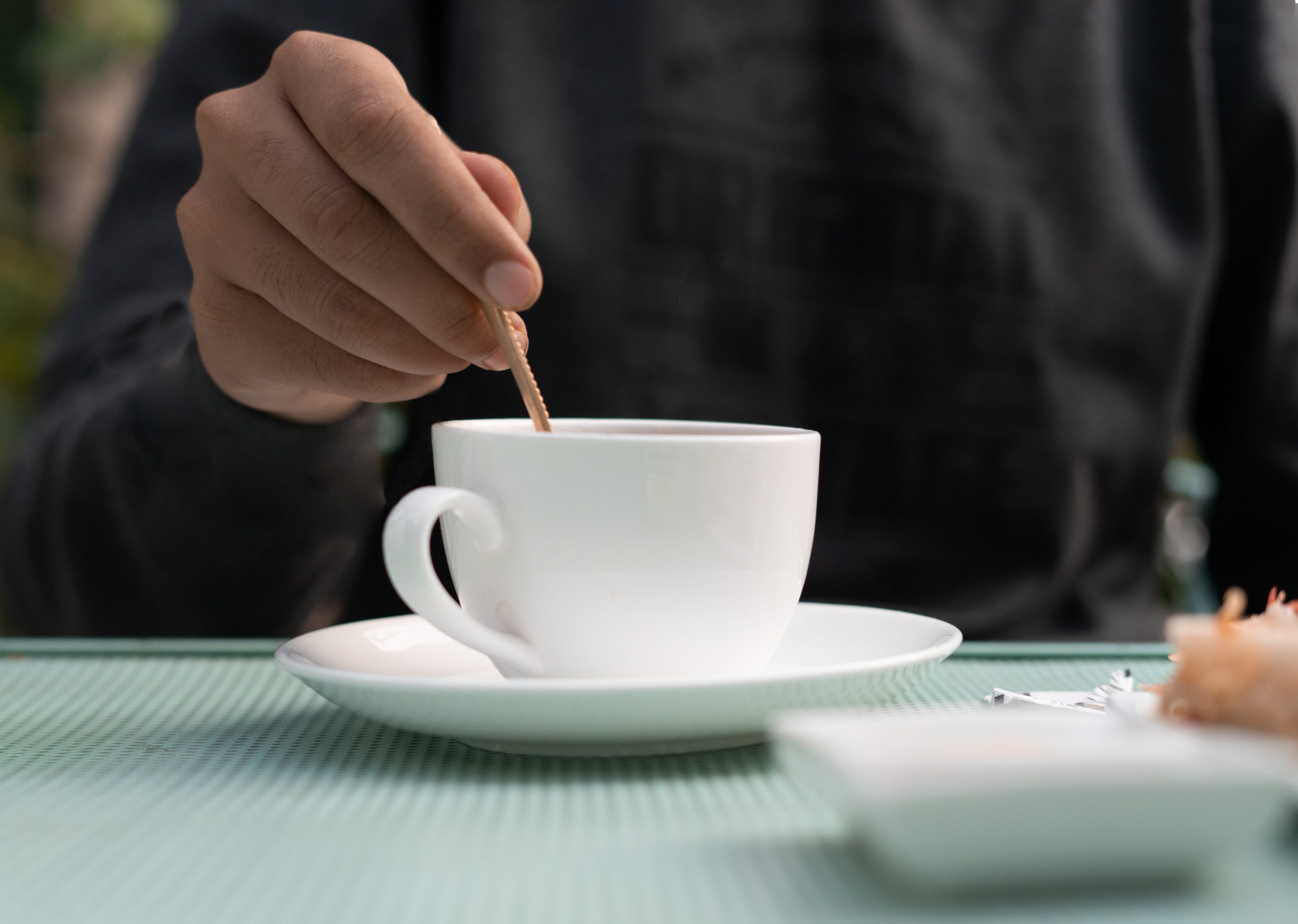 Boy mixing sugar in tea