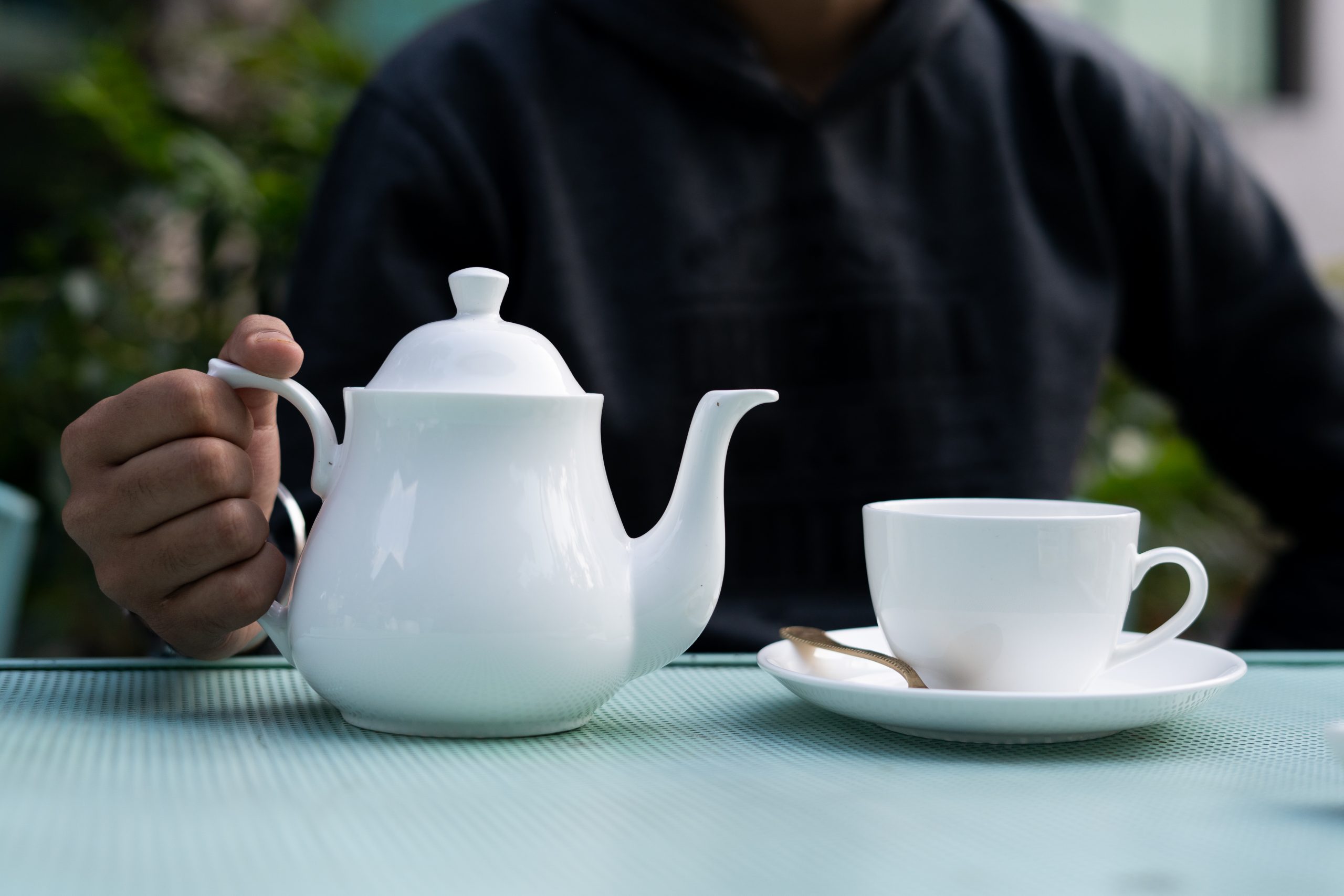 Boy pouring tea in cup