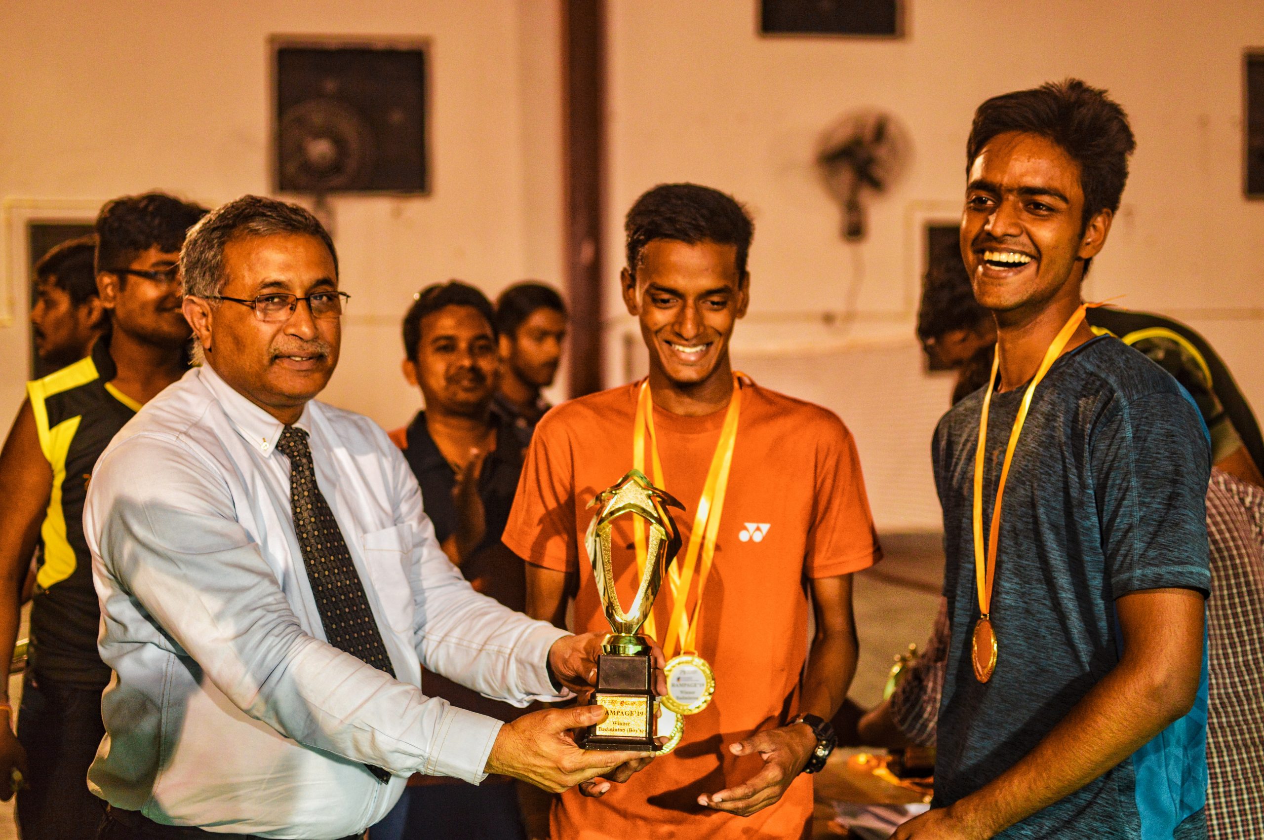 Boys receiving trophy from chief guest