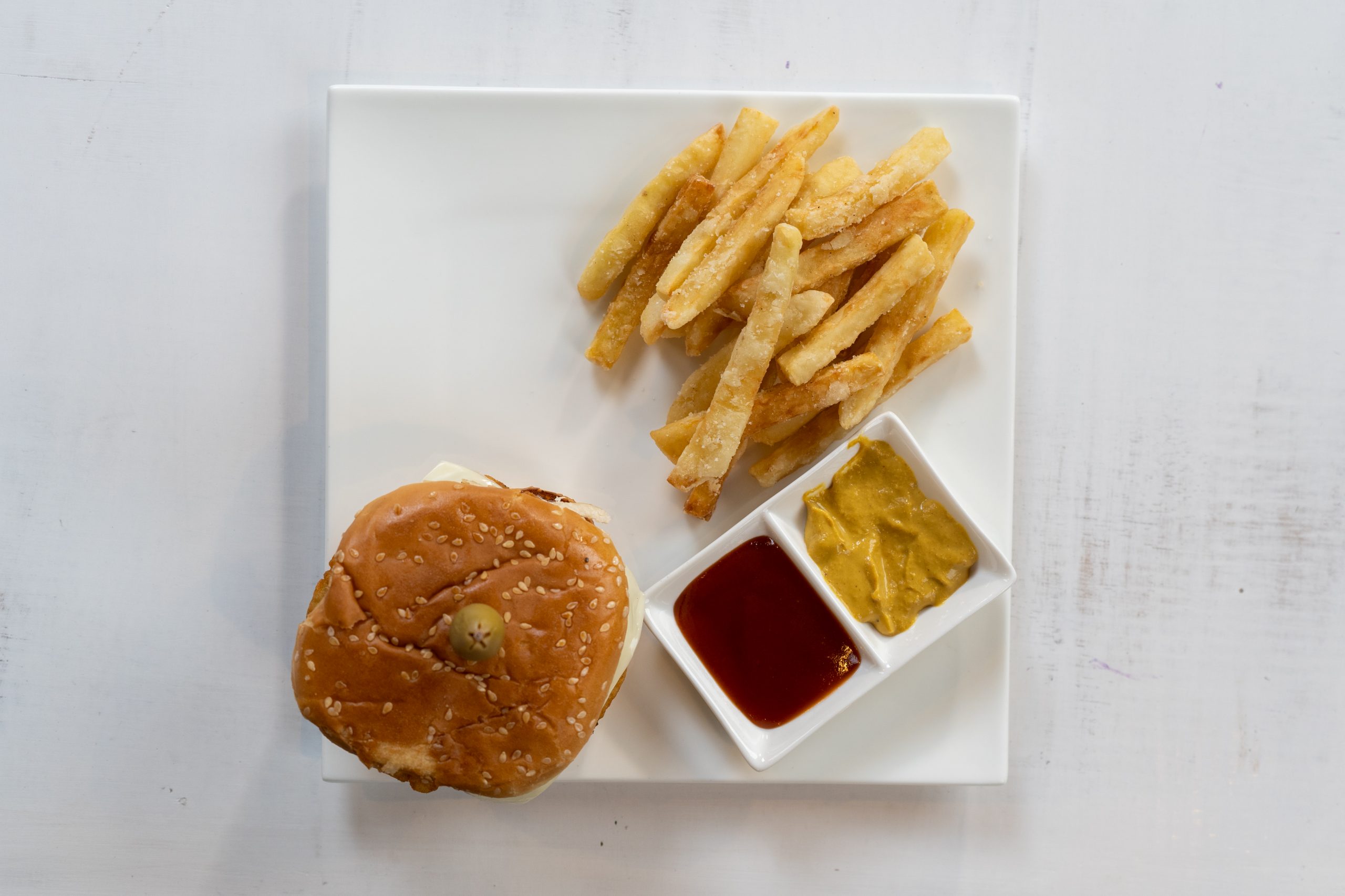 Burger and fries served in plate flatlay