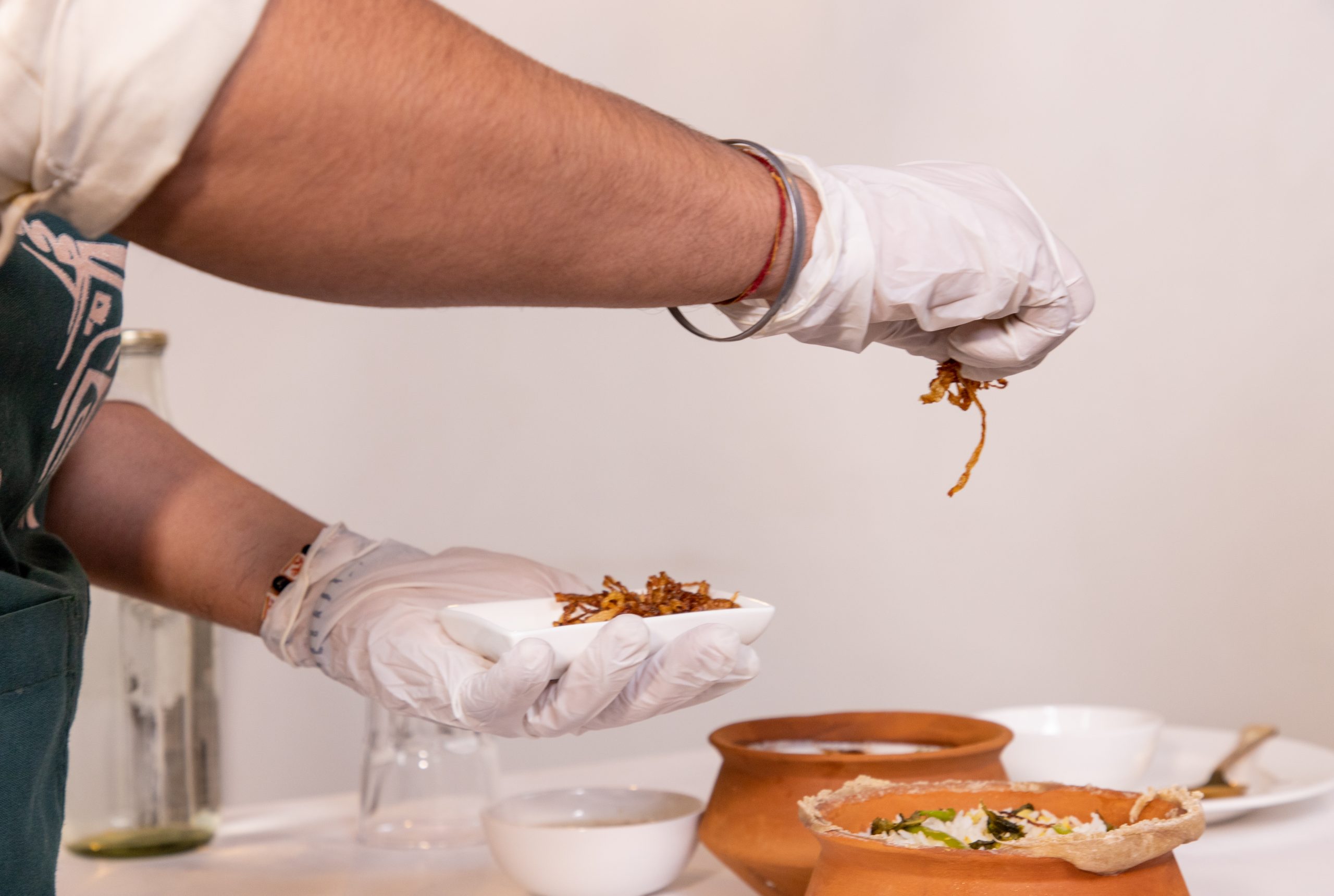 Chef garnishing biryani