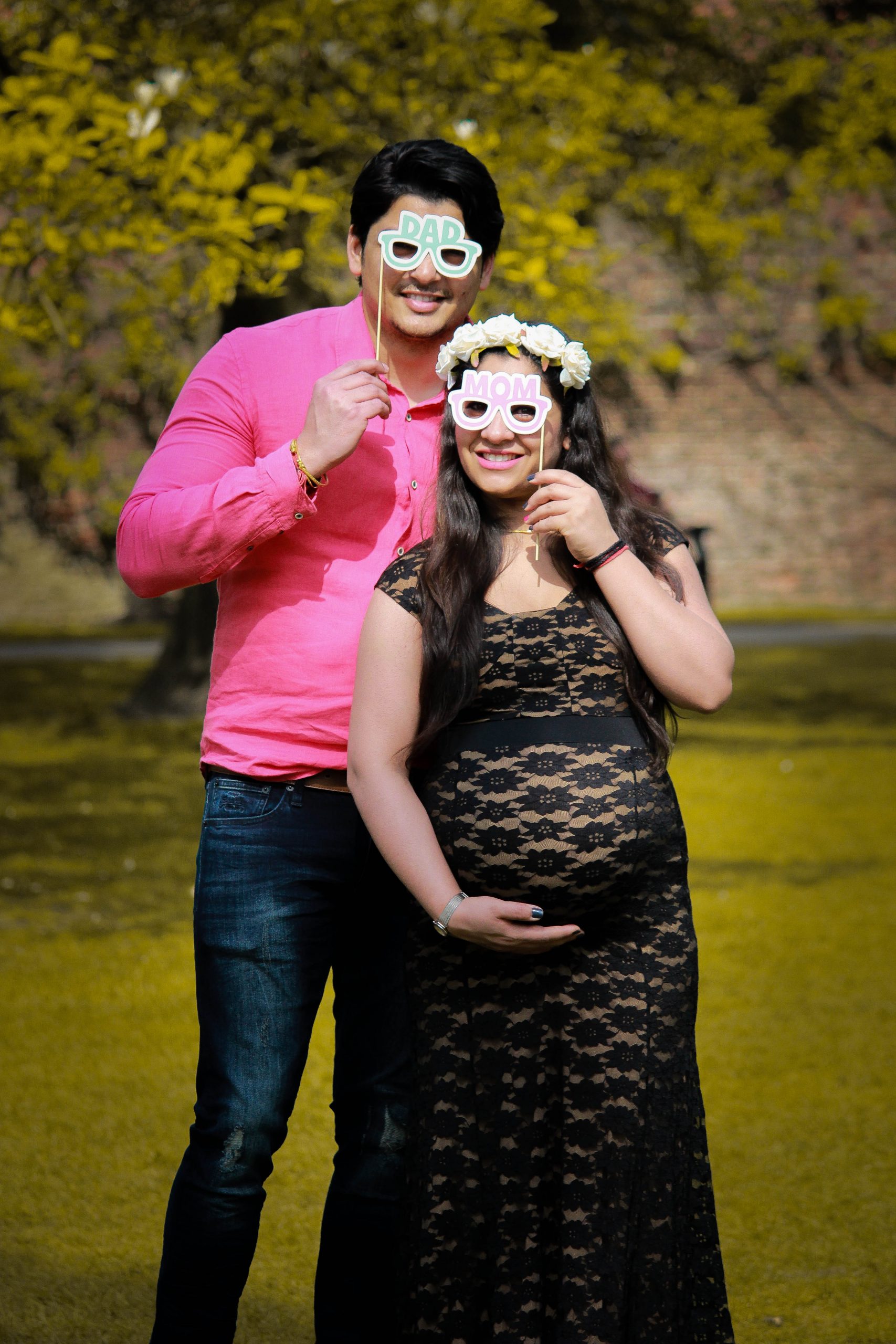 A couple about to have a baby posing for a picture.