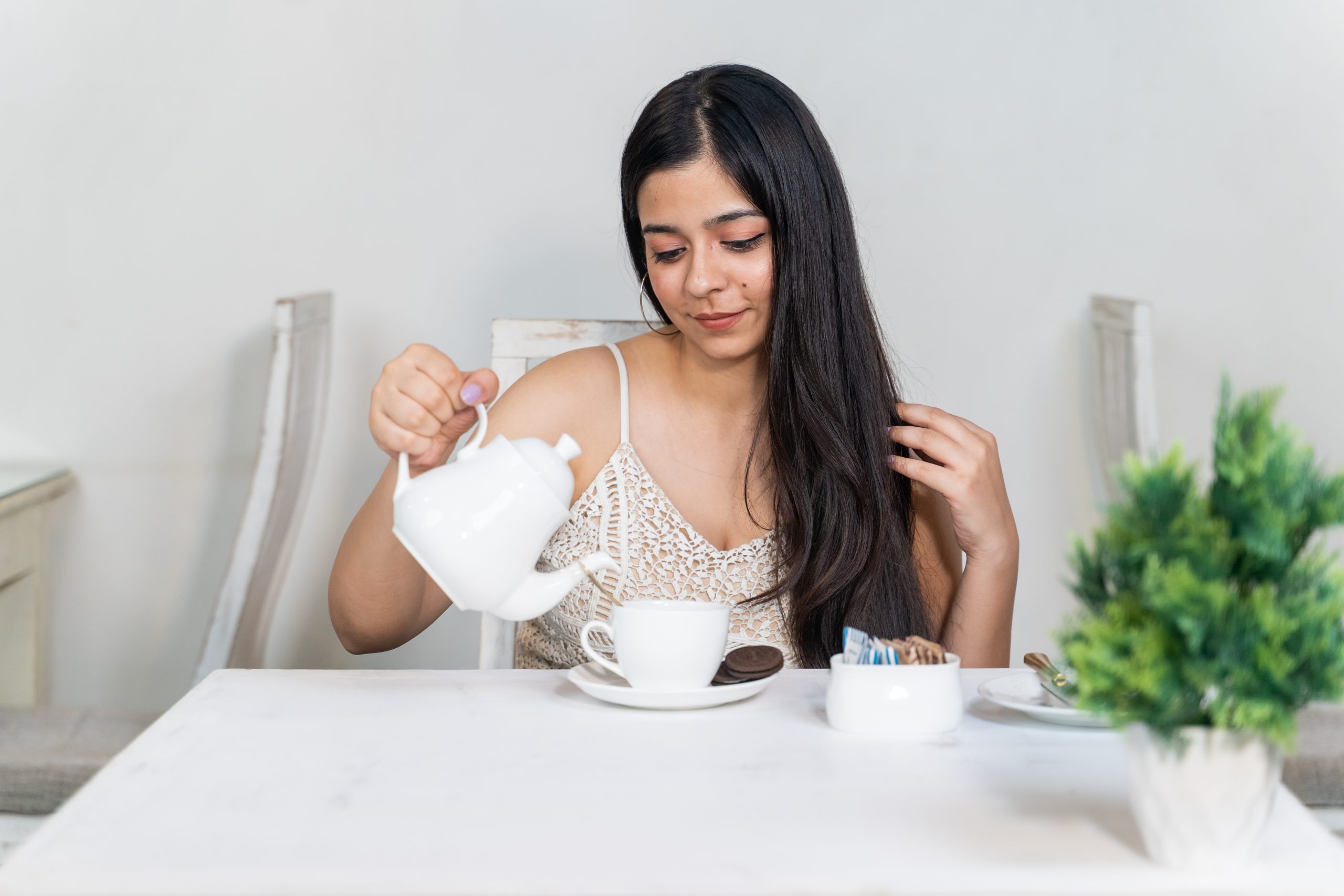 Girl pouring tea in cup