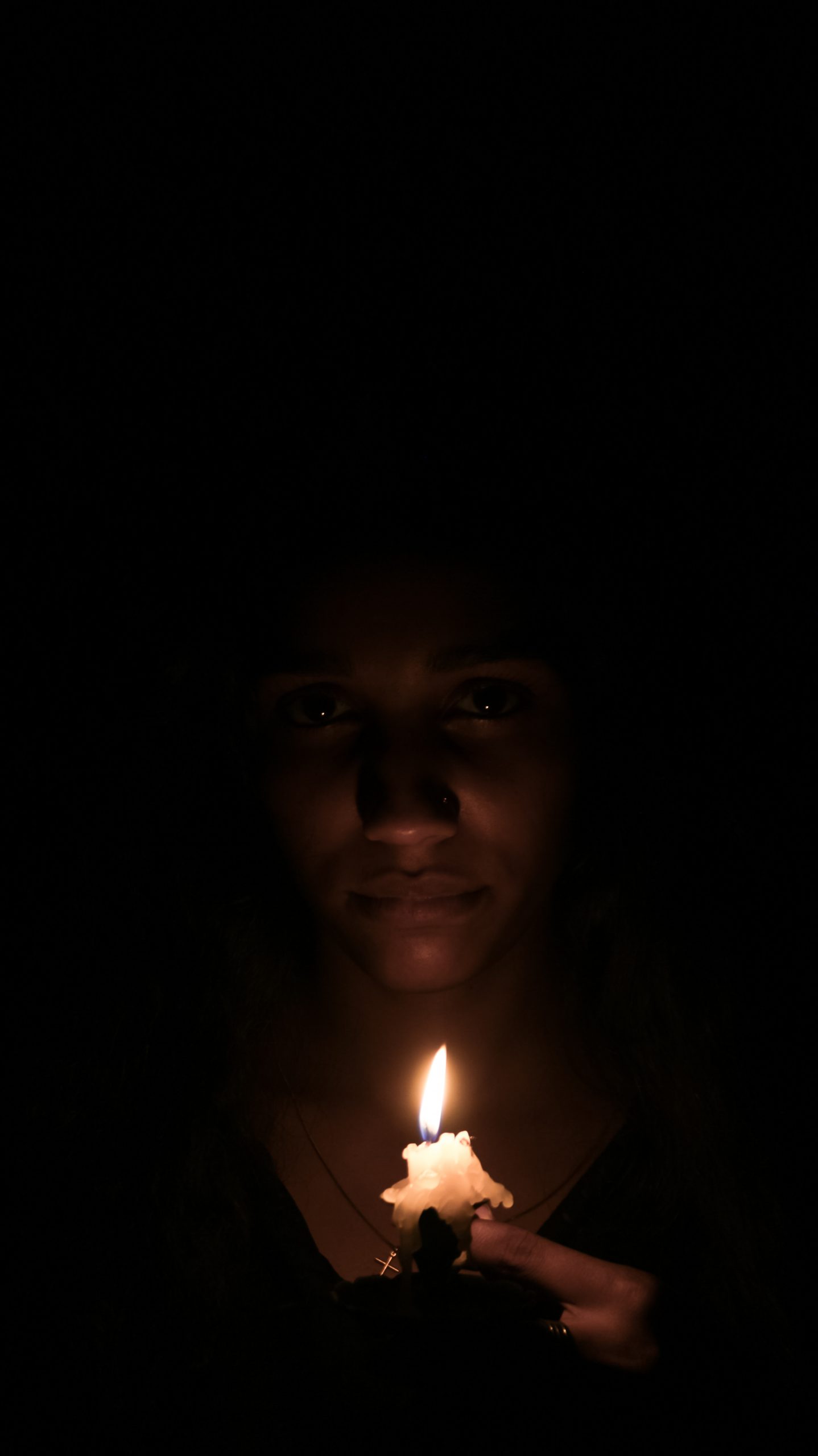 Holding a candle in darkness