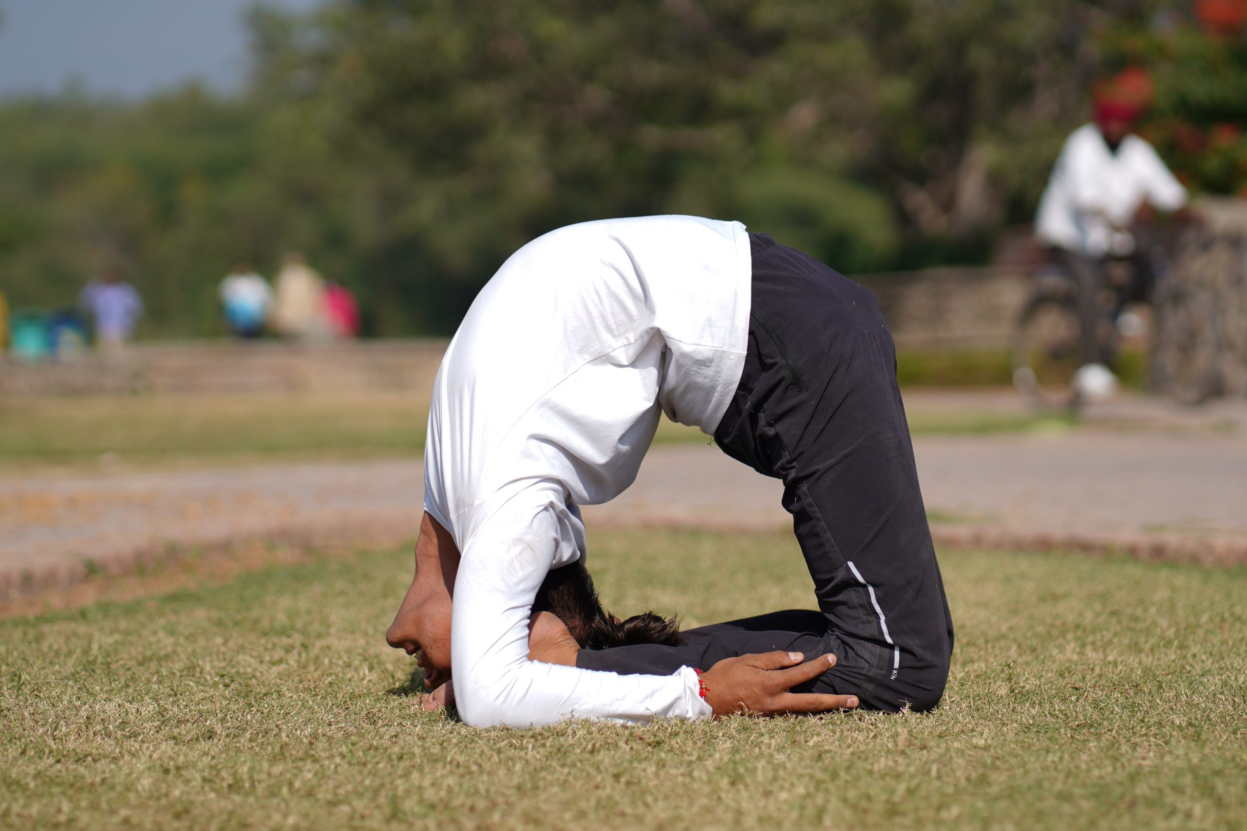 man doing yoga in garden