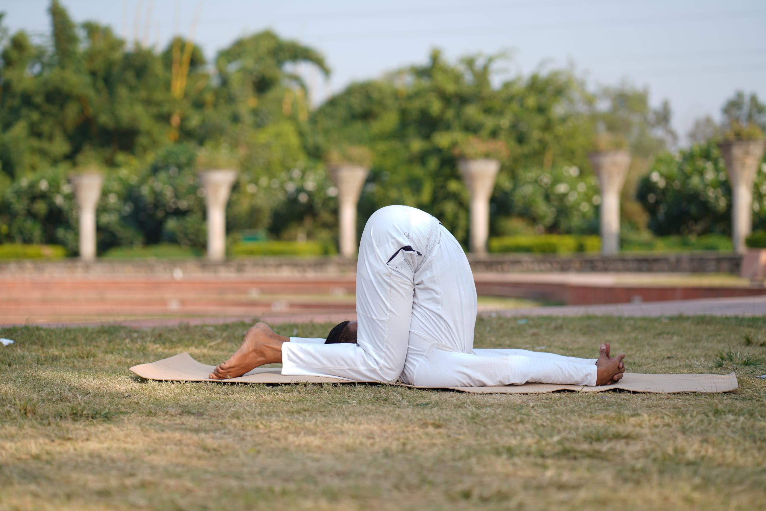 man doing yoga in garden