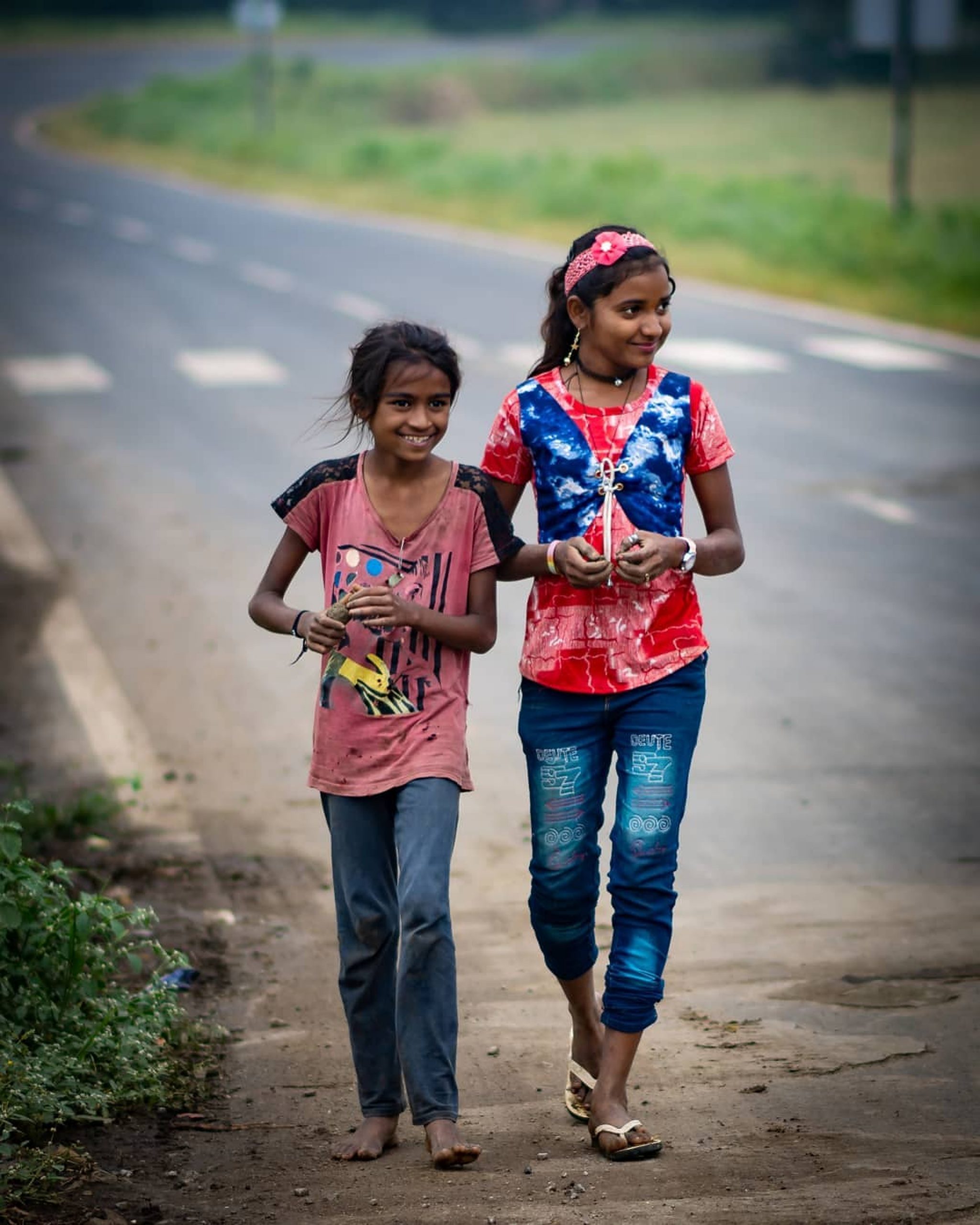 Little girls walking on a road