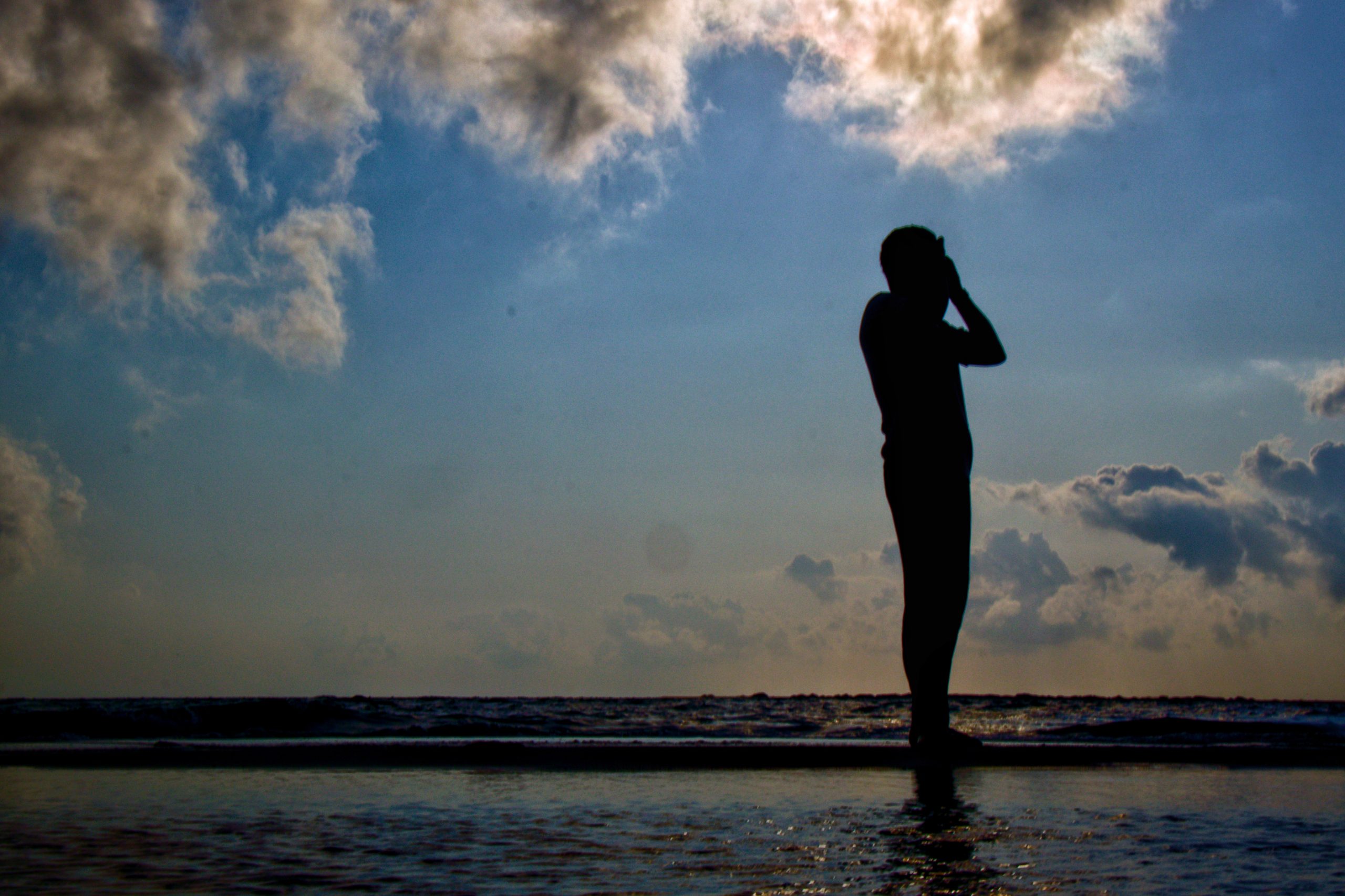 silhouette of man at the sea