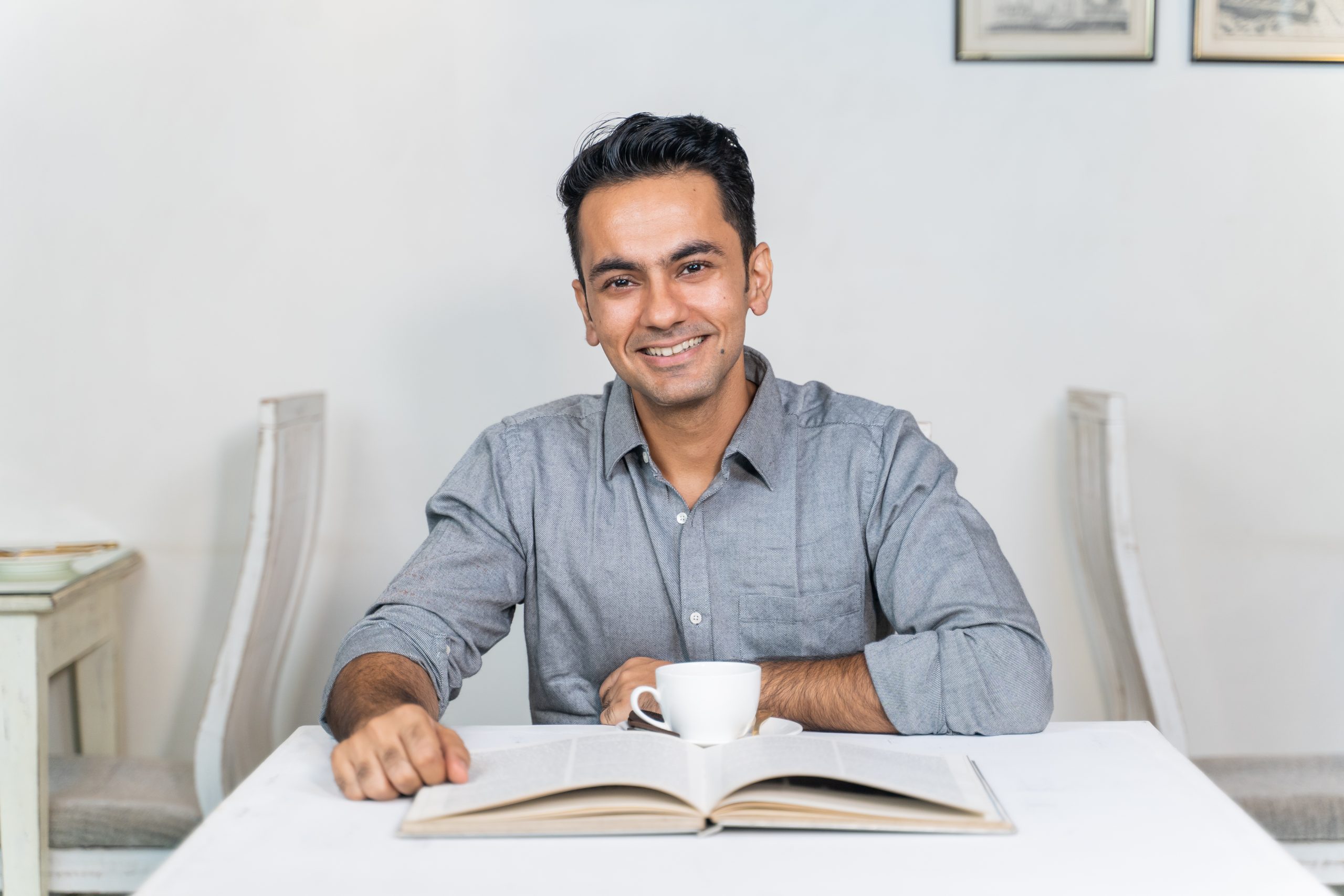 Man looking at the camera with book