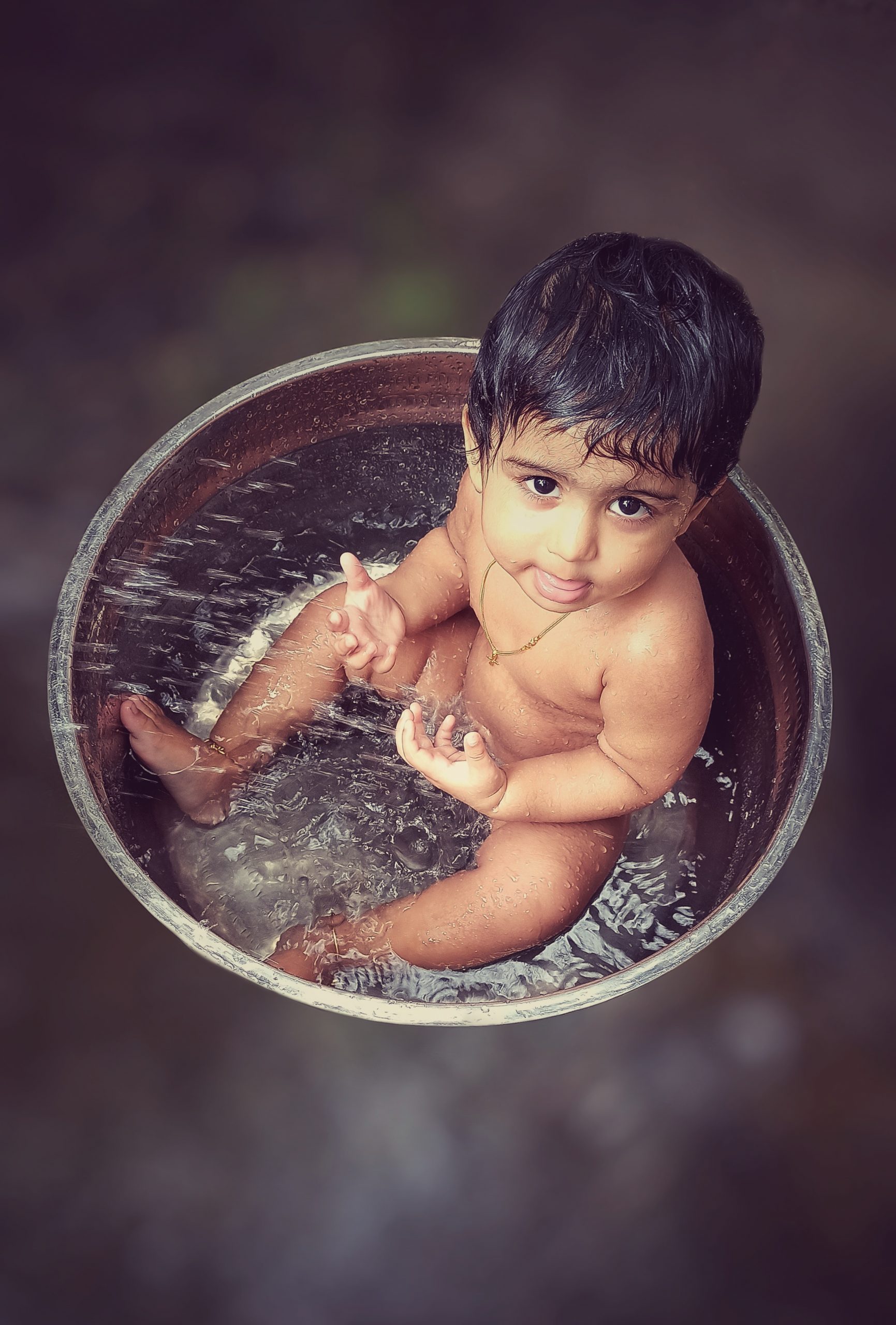 A toddler bathing in a tub