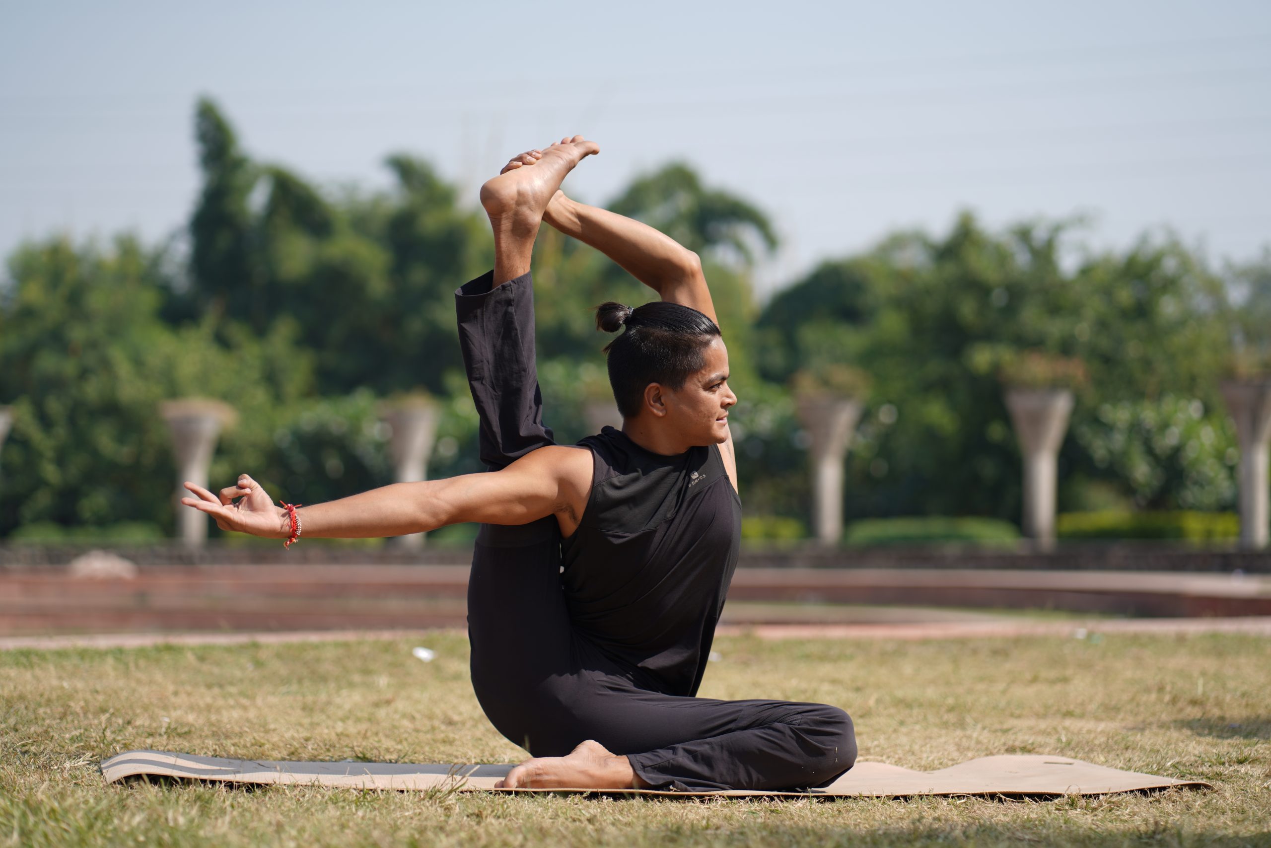 man doing yoga in garden