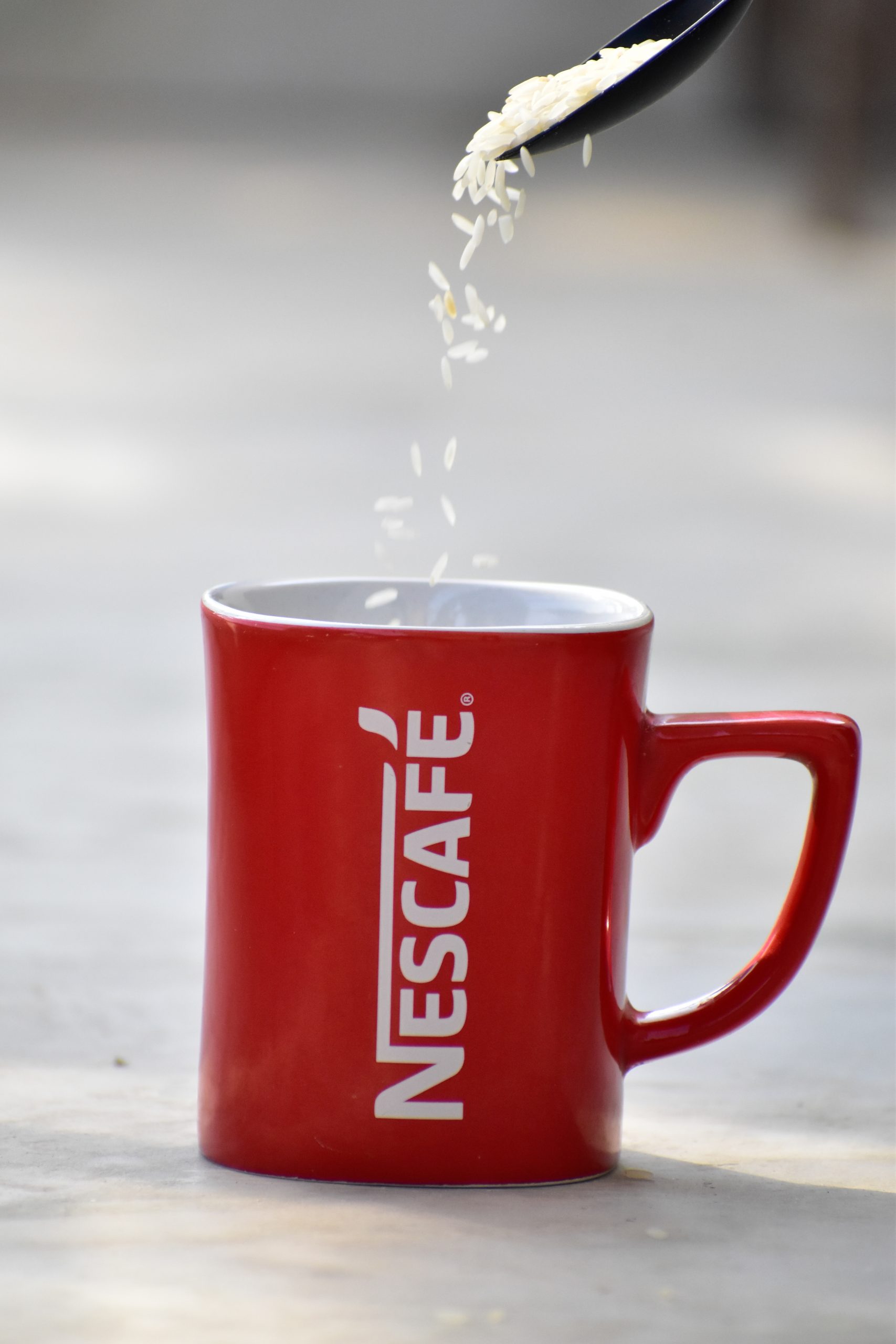 rice grains falling in a mug