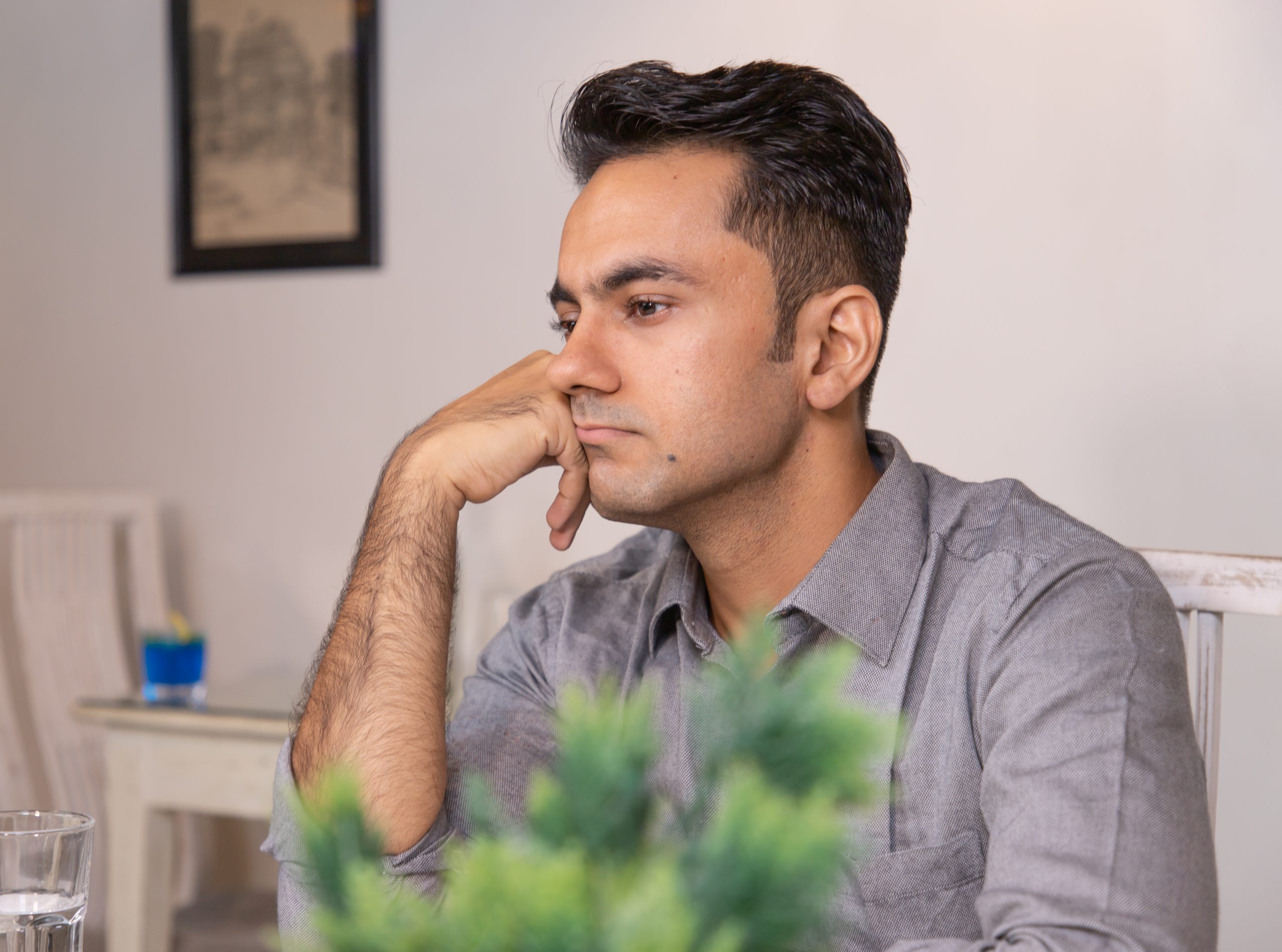 Sad looking man sitting in cafe