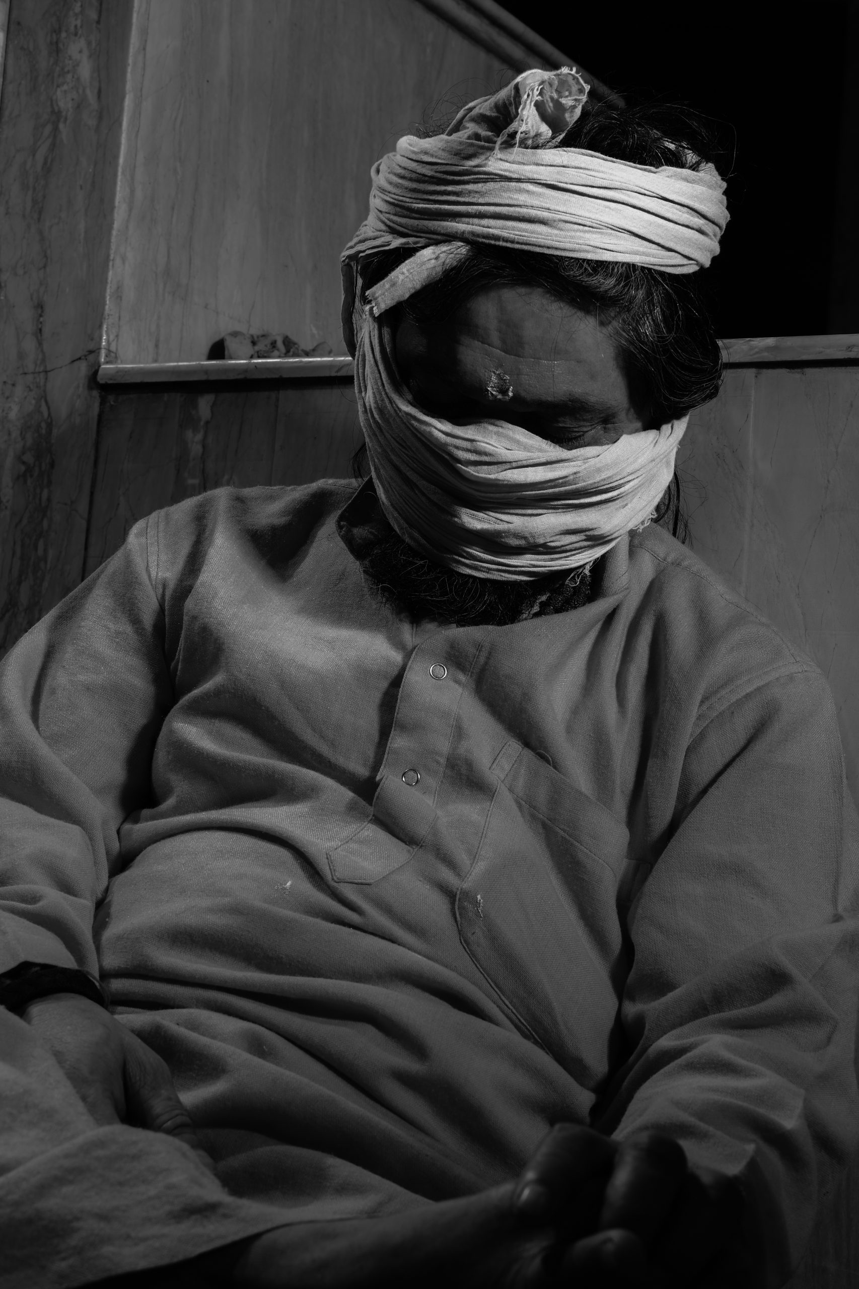 A man sleeping after covering his face