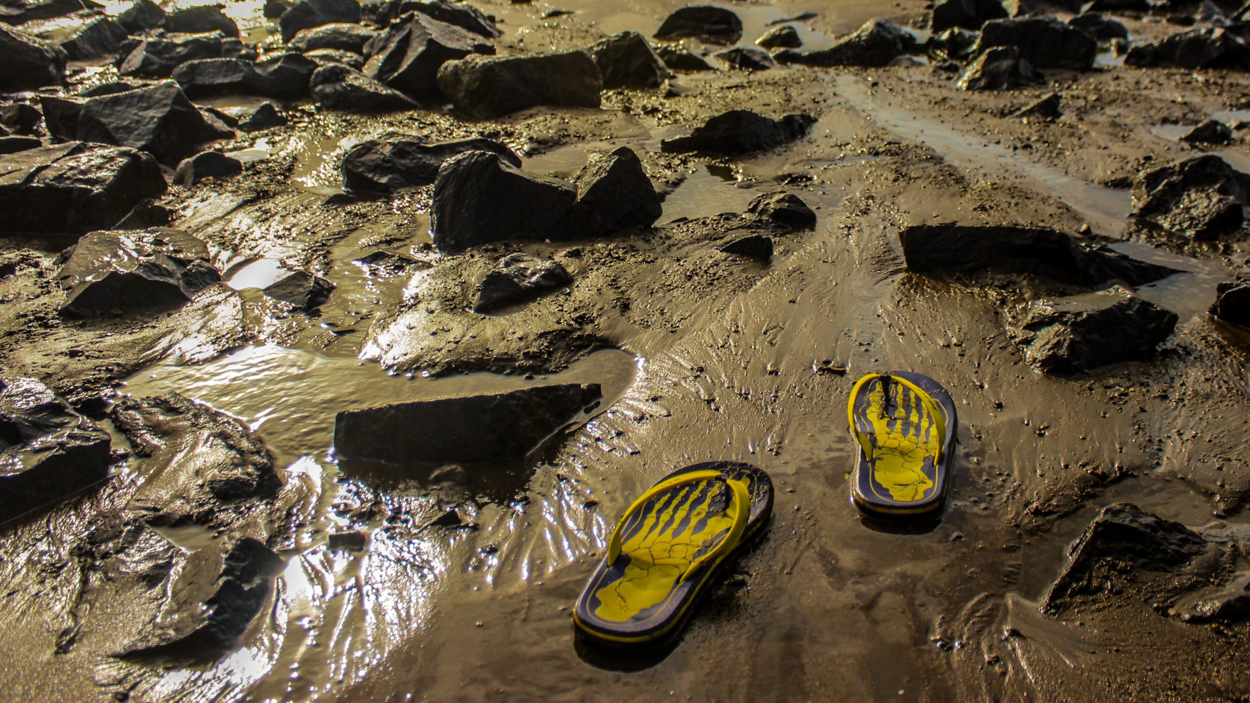 Slippers in a rocky beach