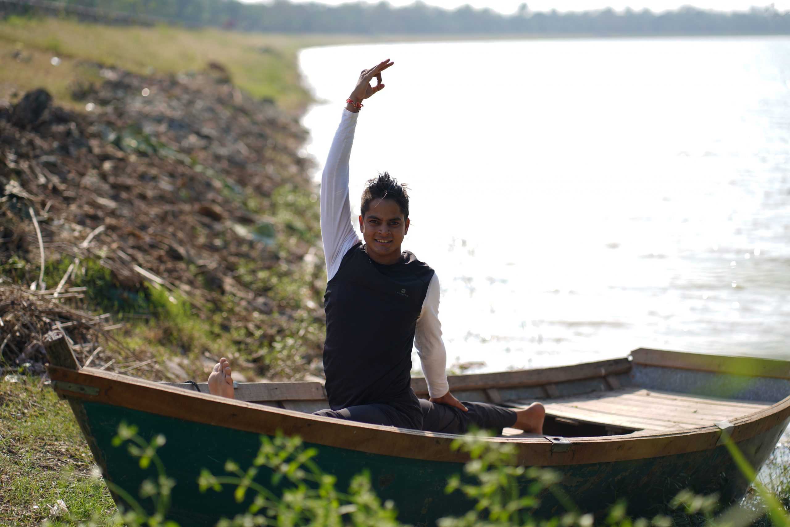 man doing yoga on a boat