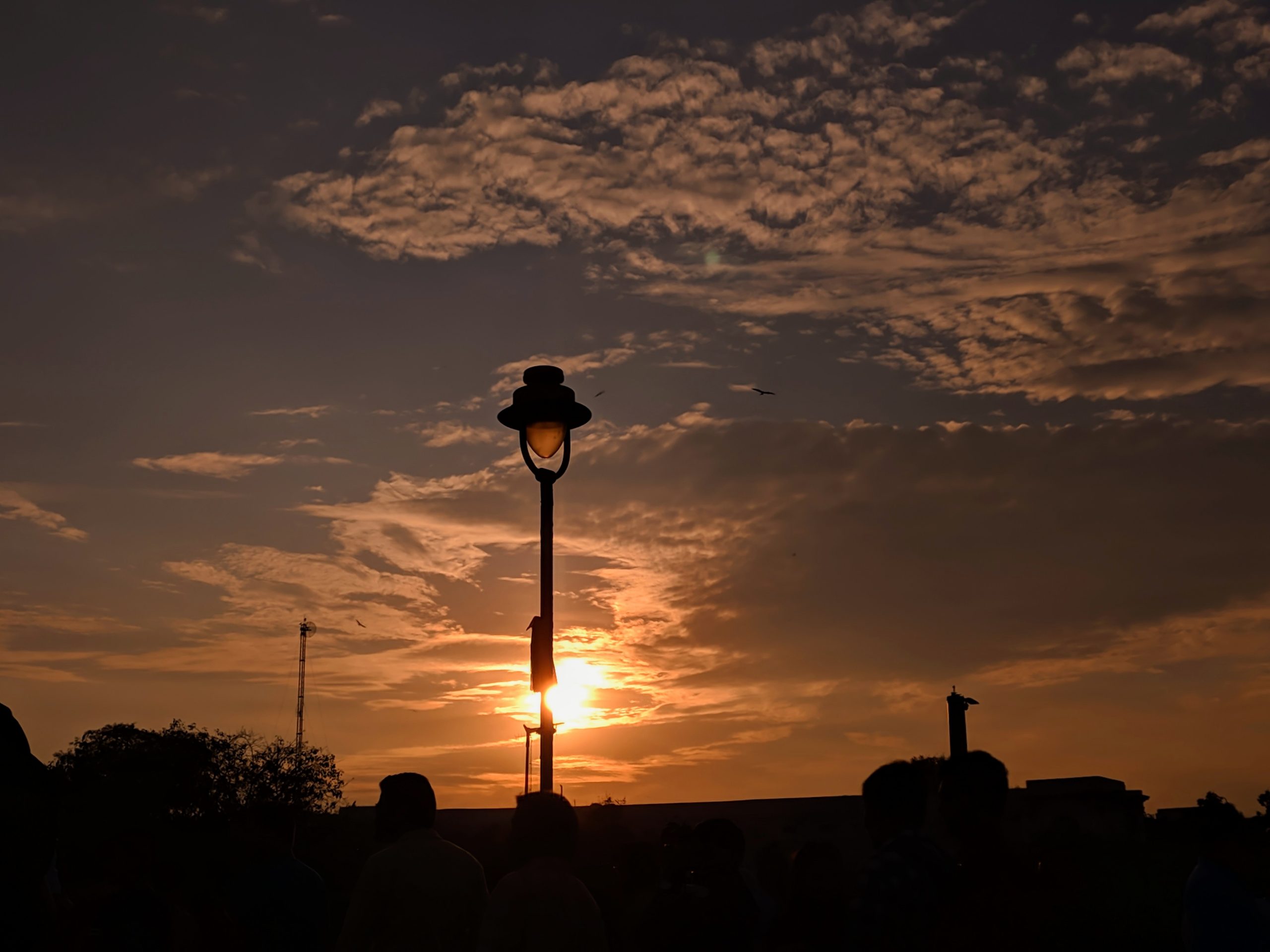 Sunset through a light pole