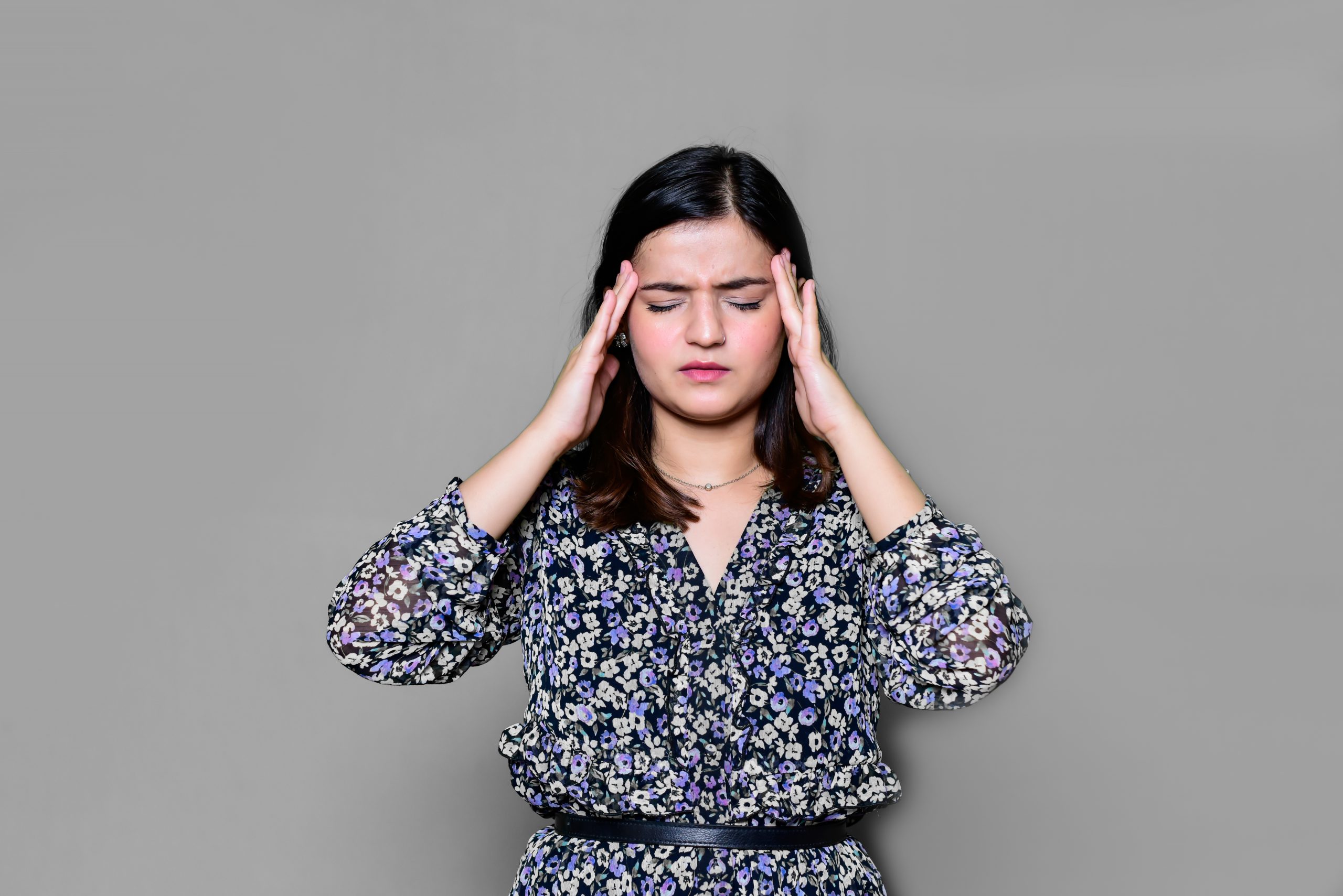 A woman dealing with migraine.