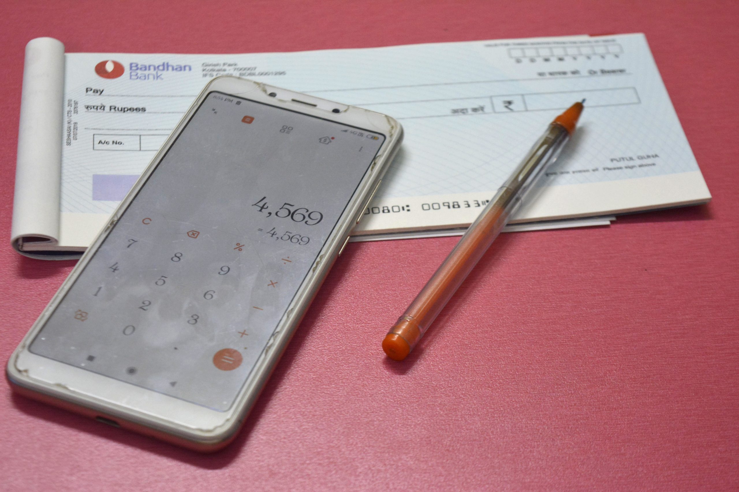 cheque book and mobile calculator