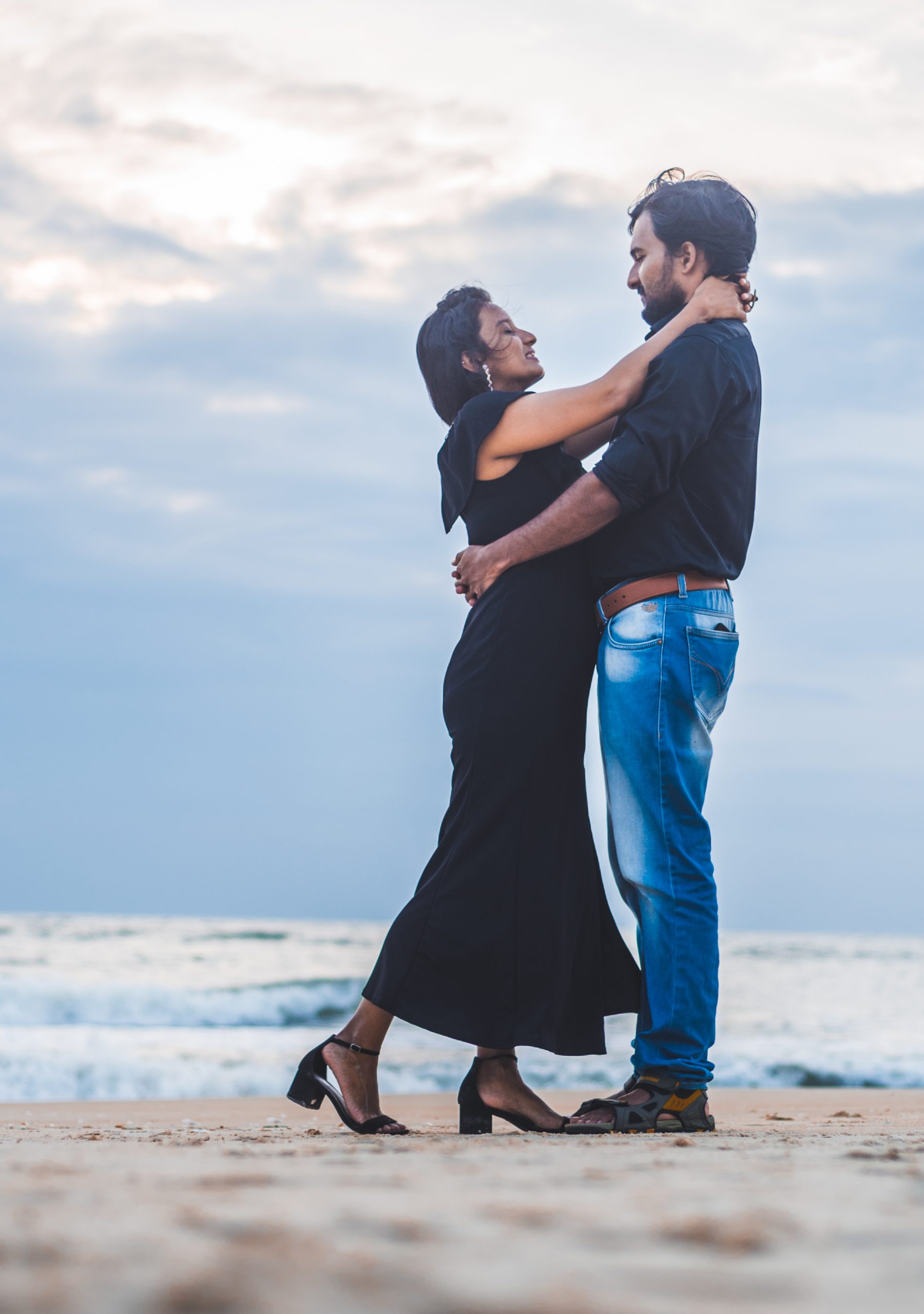 couple posing by the beach