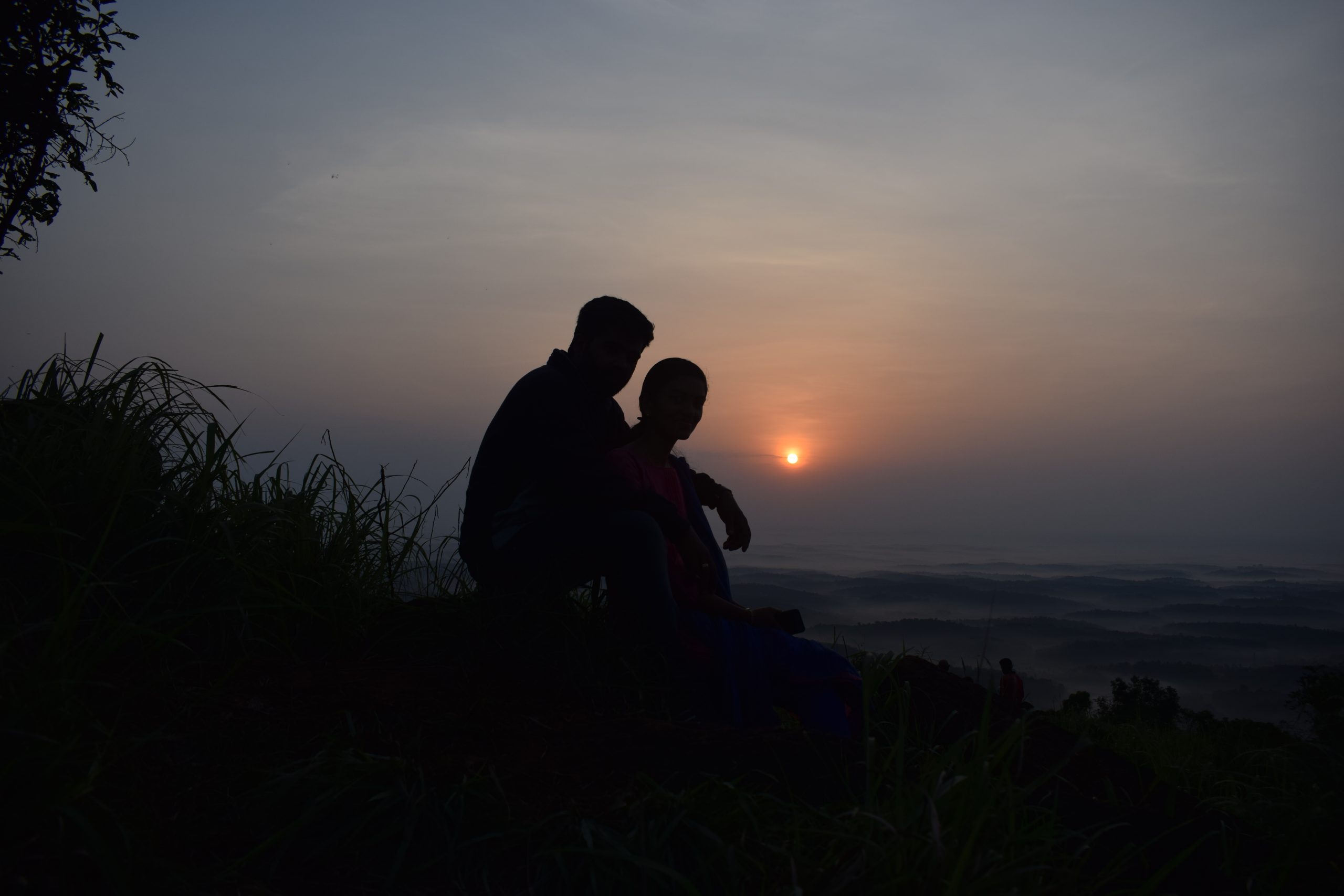 silhouette of a couple on hill top