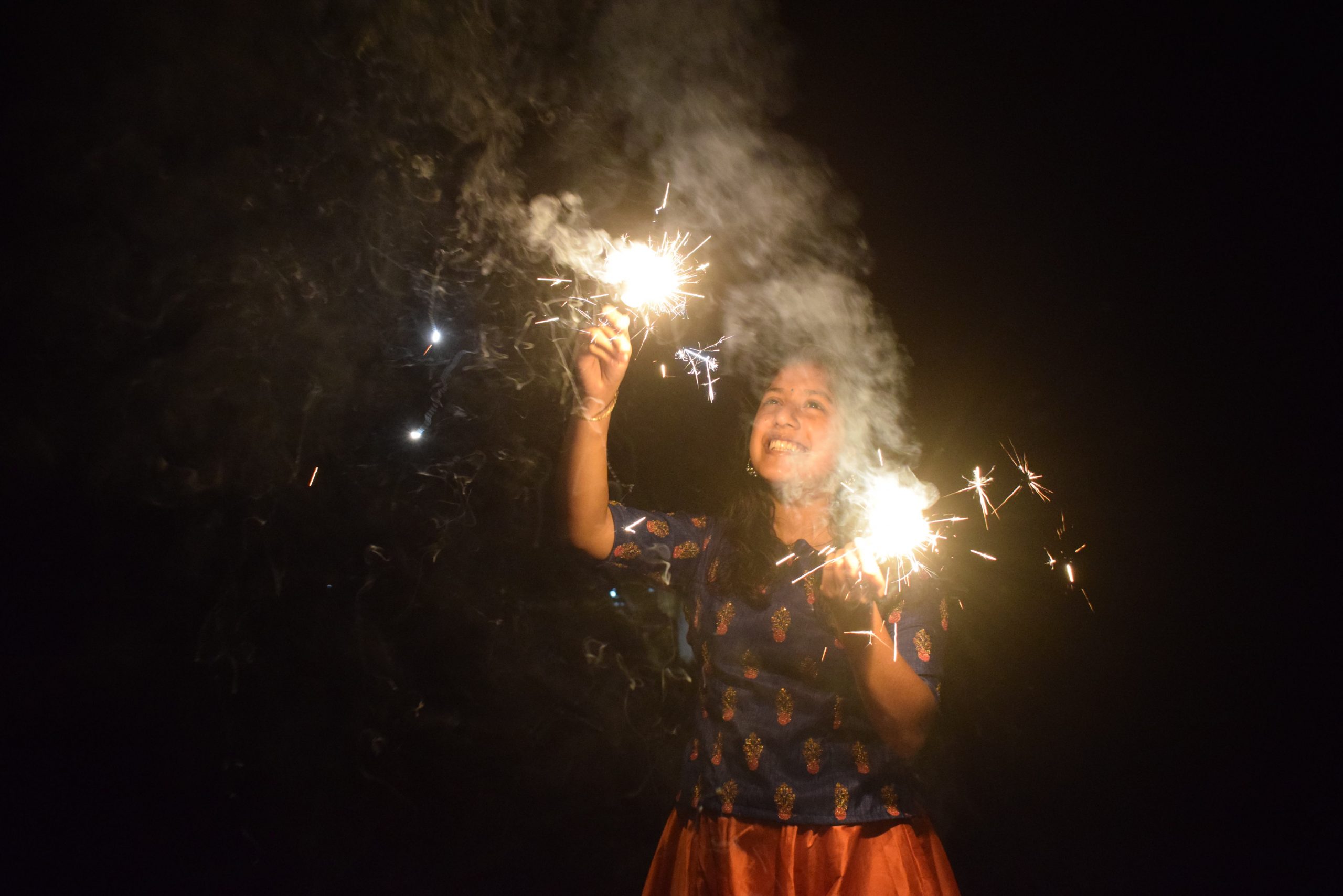girl lighting fireworks