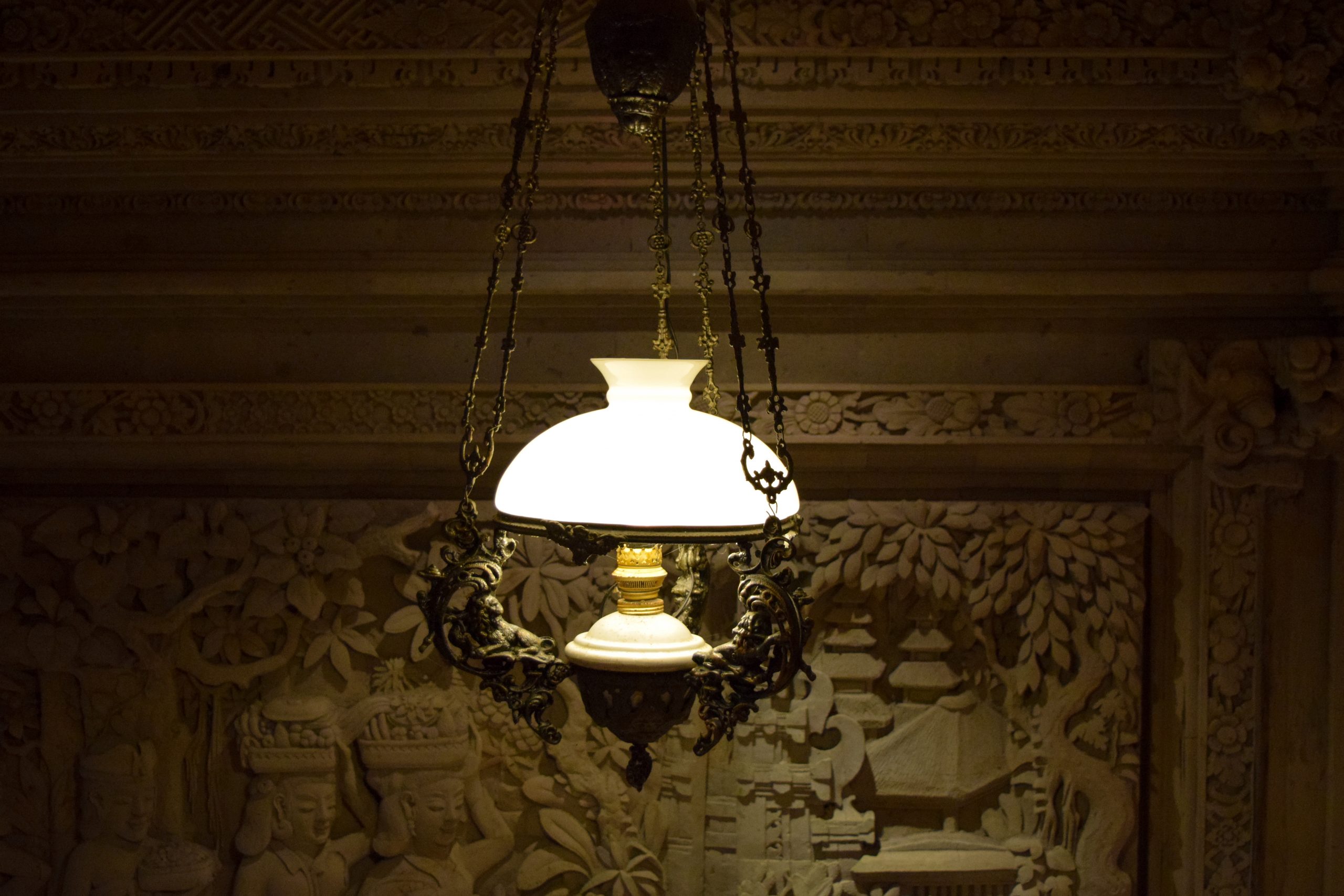 Beautiful lamp in front of carvings