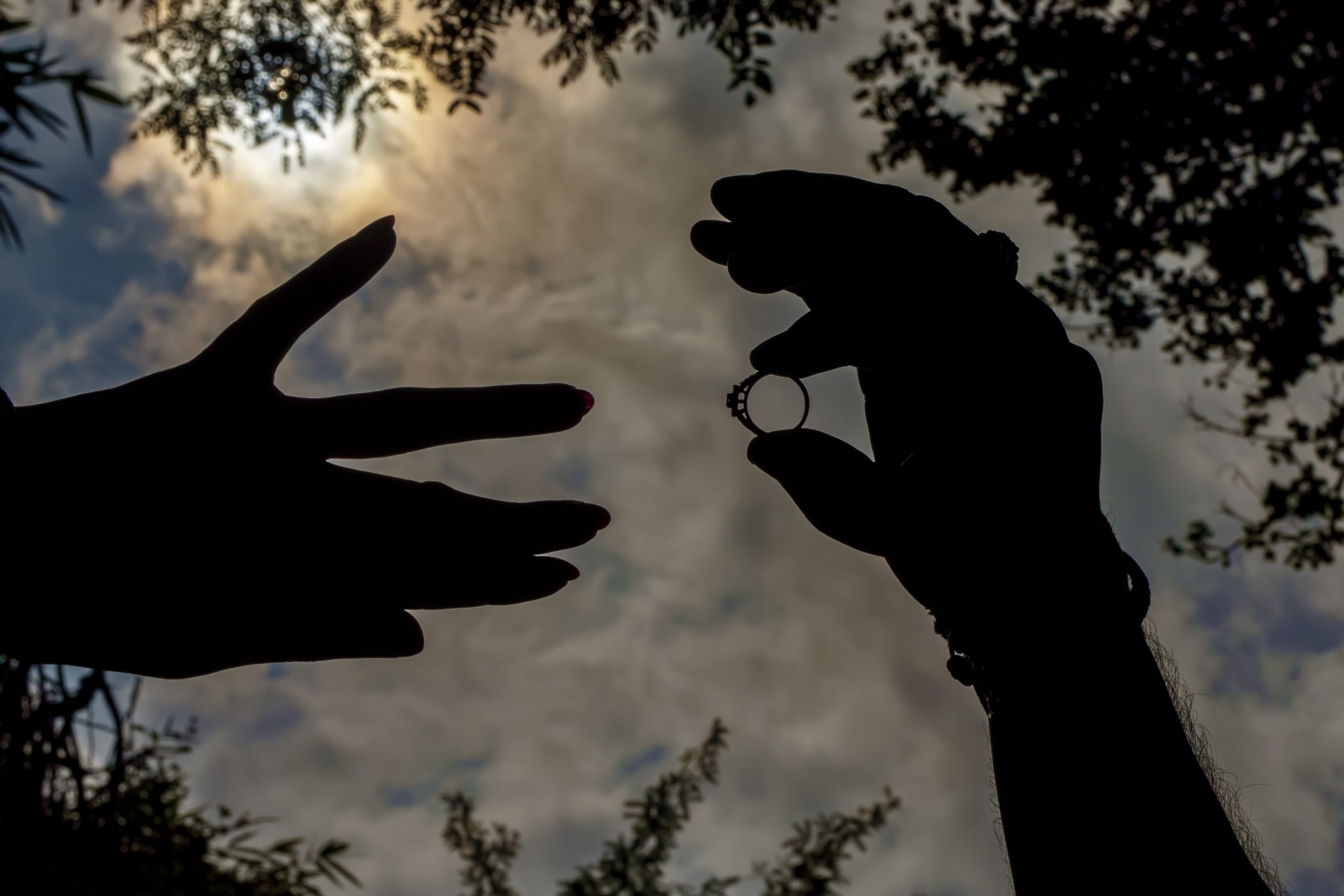 silhouette of hands with ring