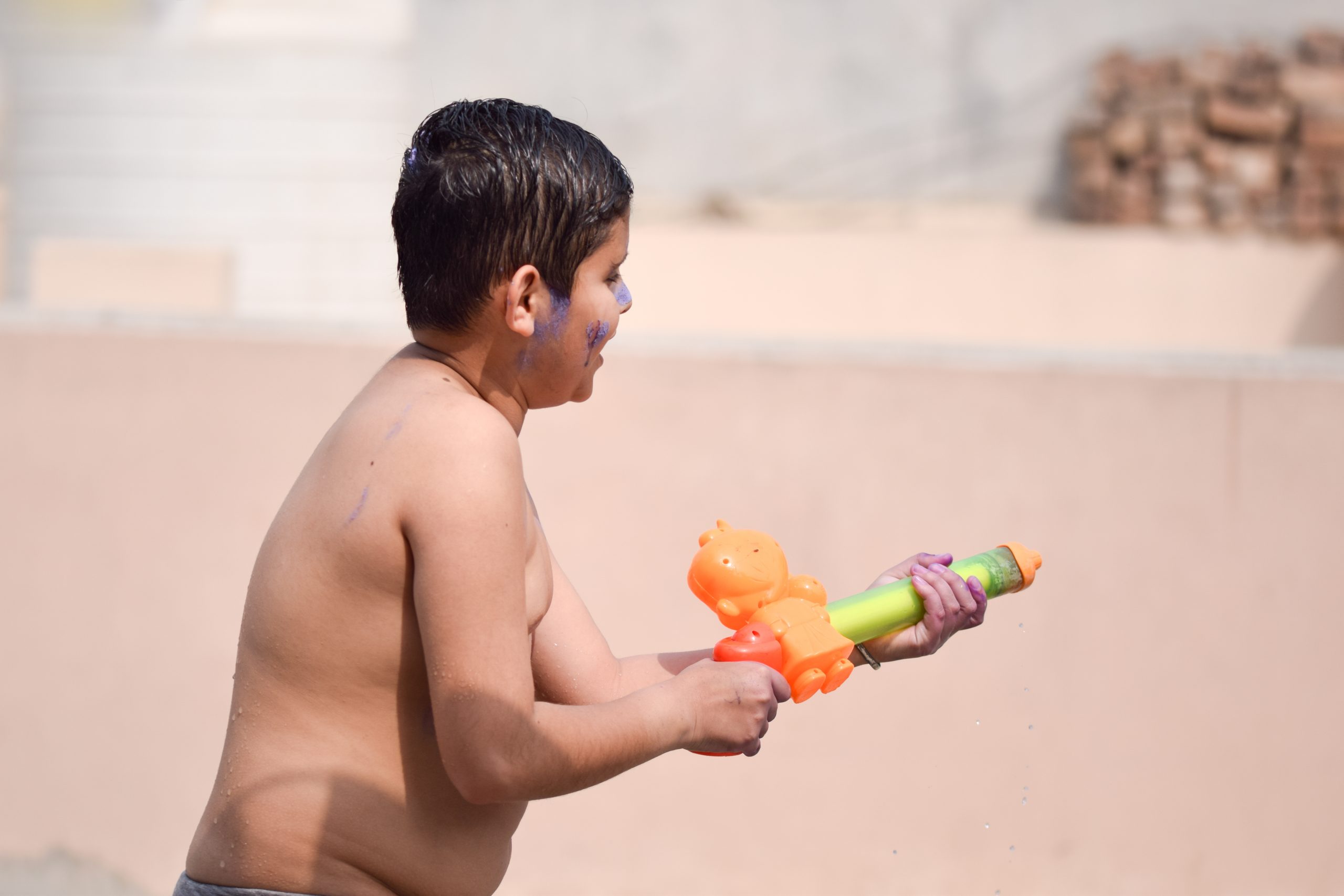 boy playing with water gun