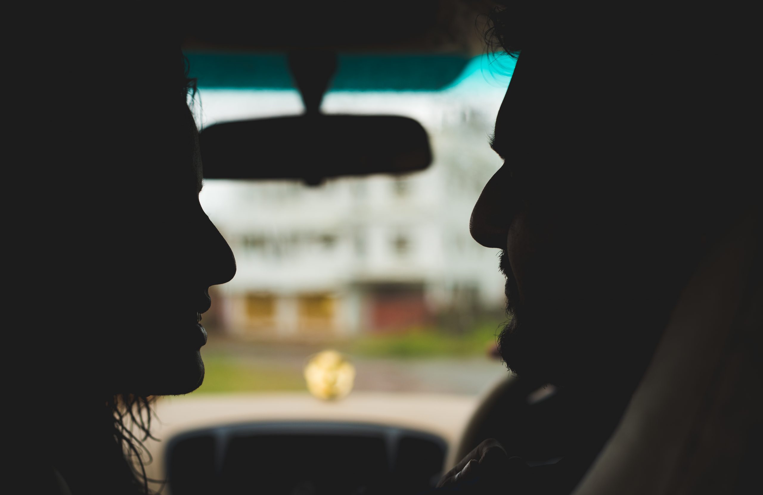 silhouette of couple in a car