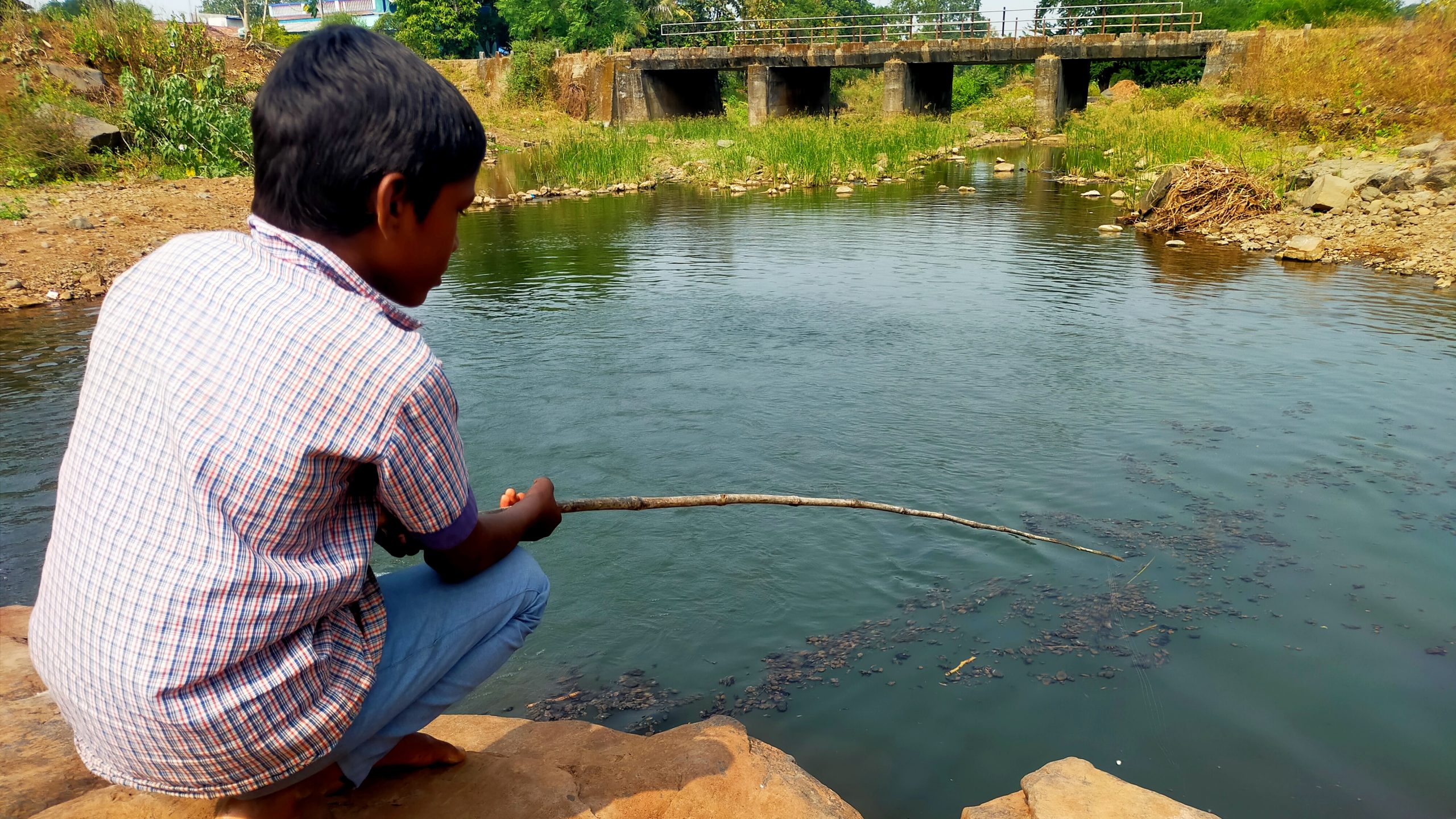 A boy fishing in a pond