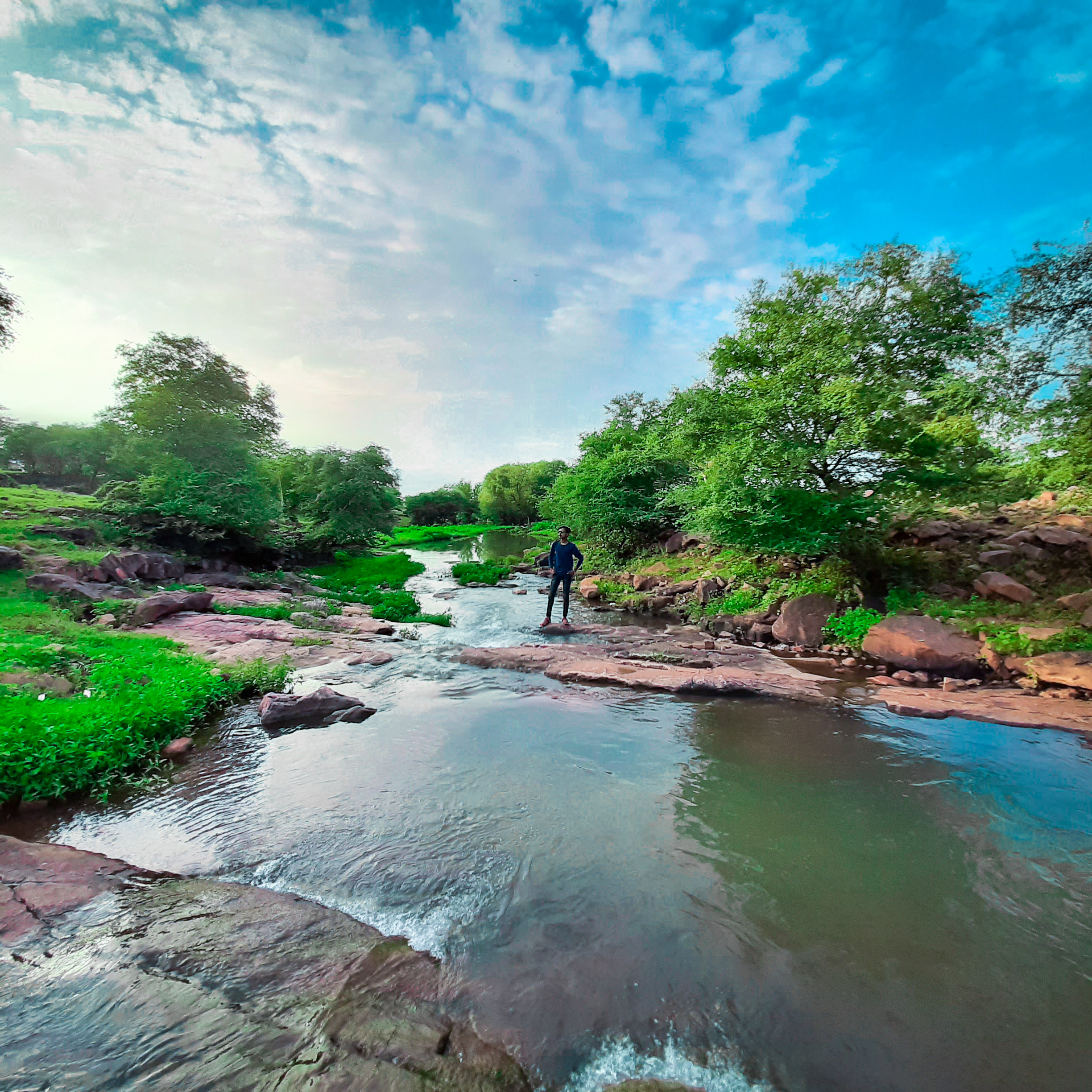 A boy in a rocky river