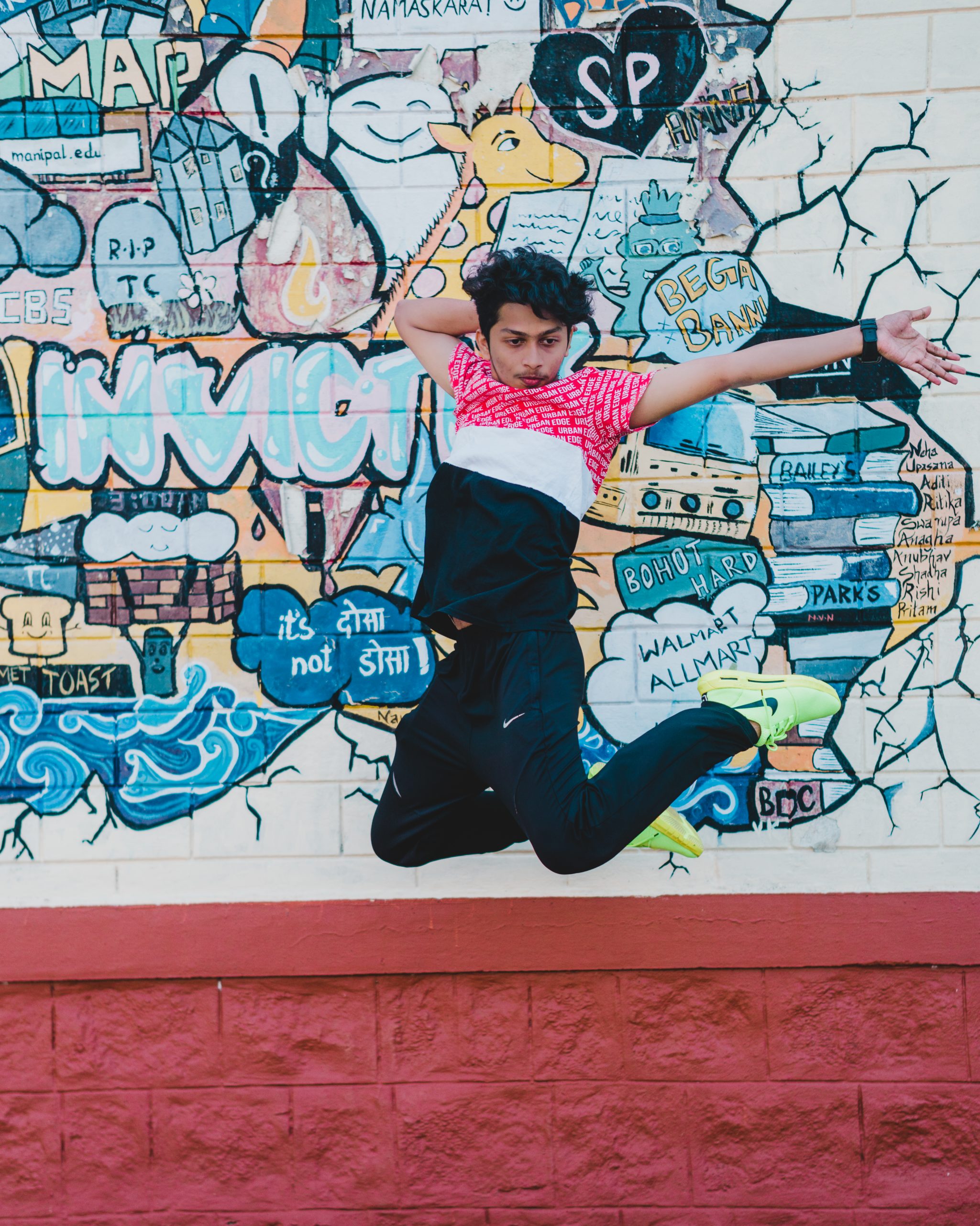 A boy jumping near a wall