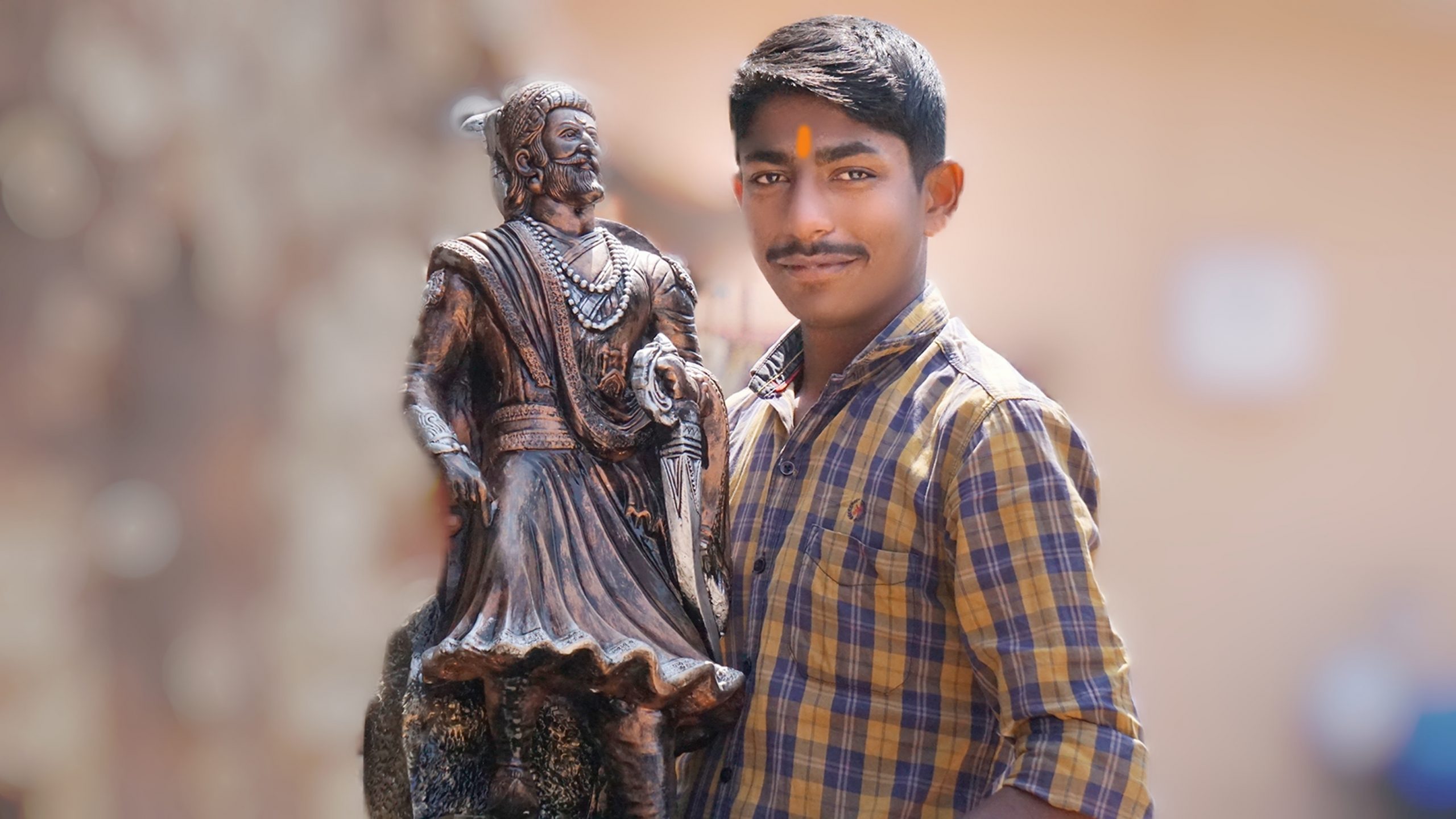 A boy near statue of Shivaji Maharaj