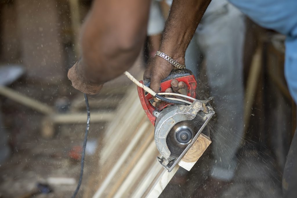 A carpenter cutting wood with a cutter PixaHive