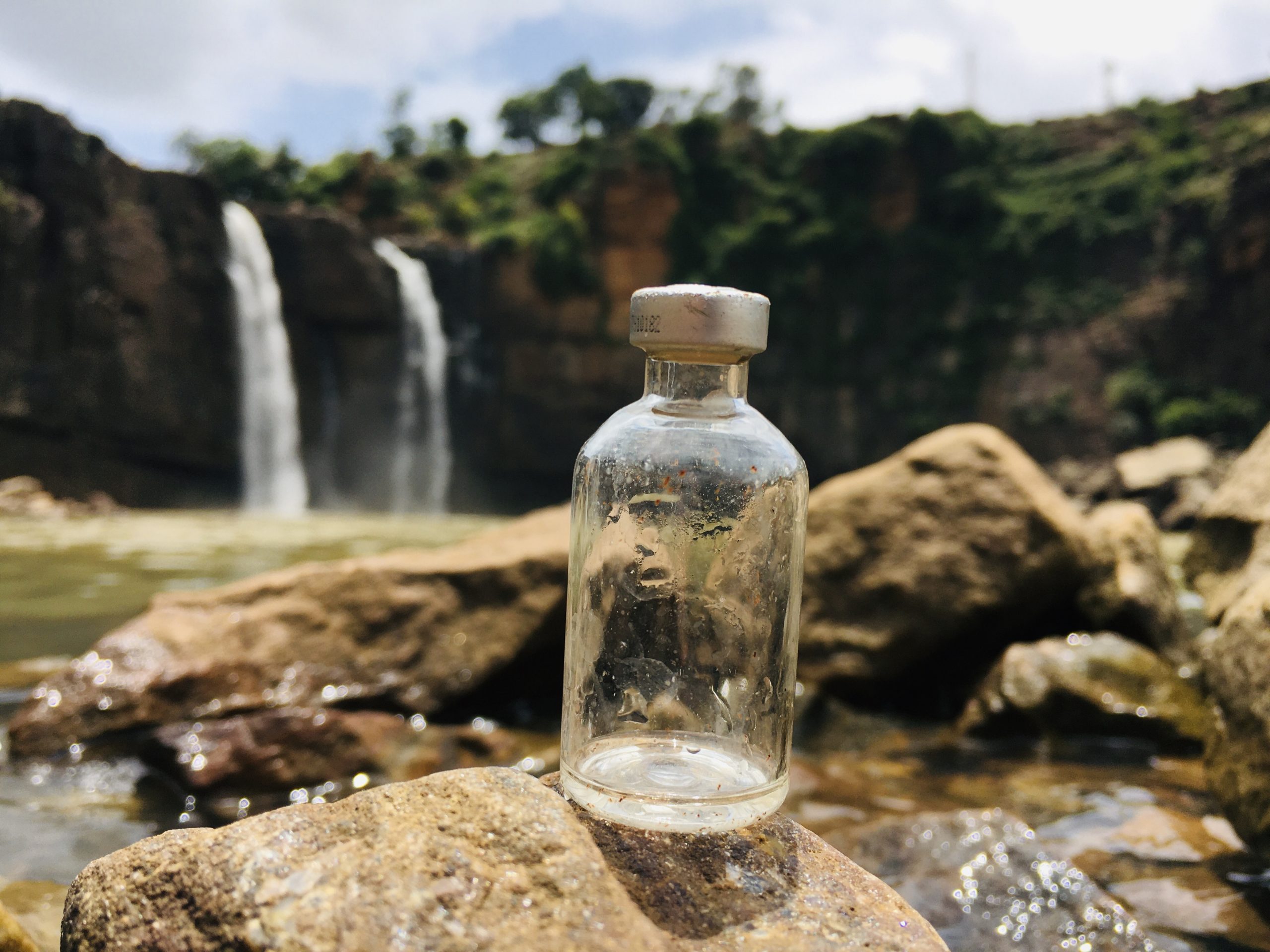 A glass bottle on a rock