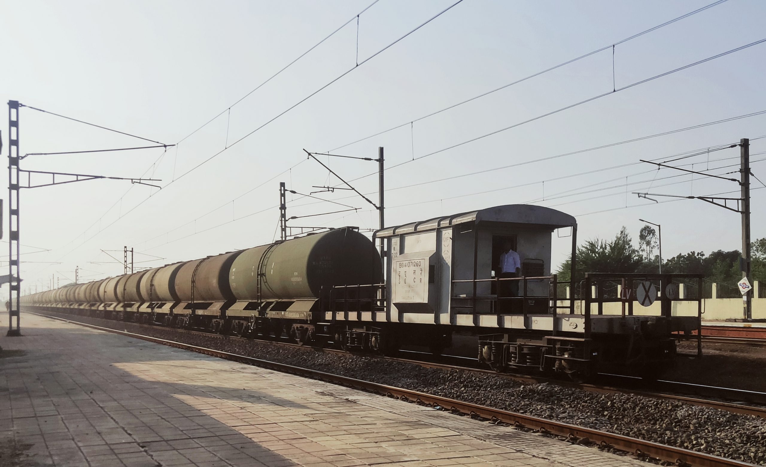 A goods train carrying oil tankers