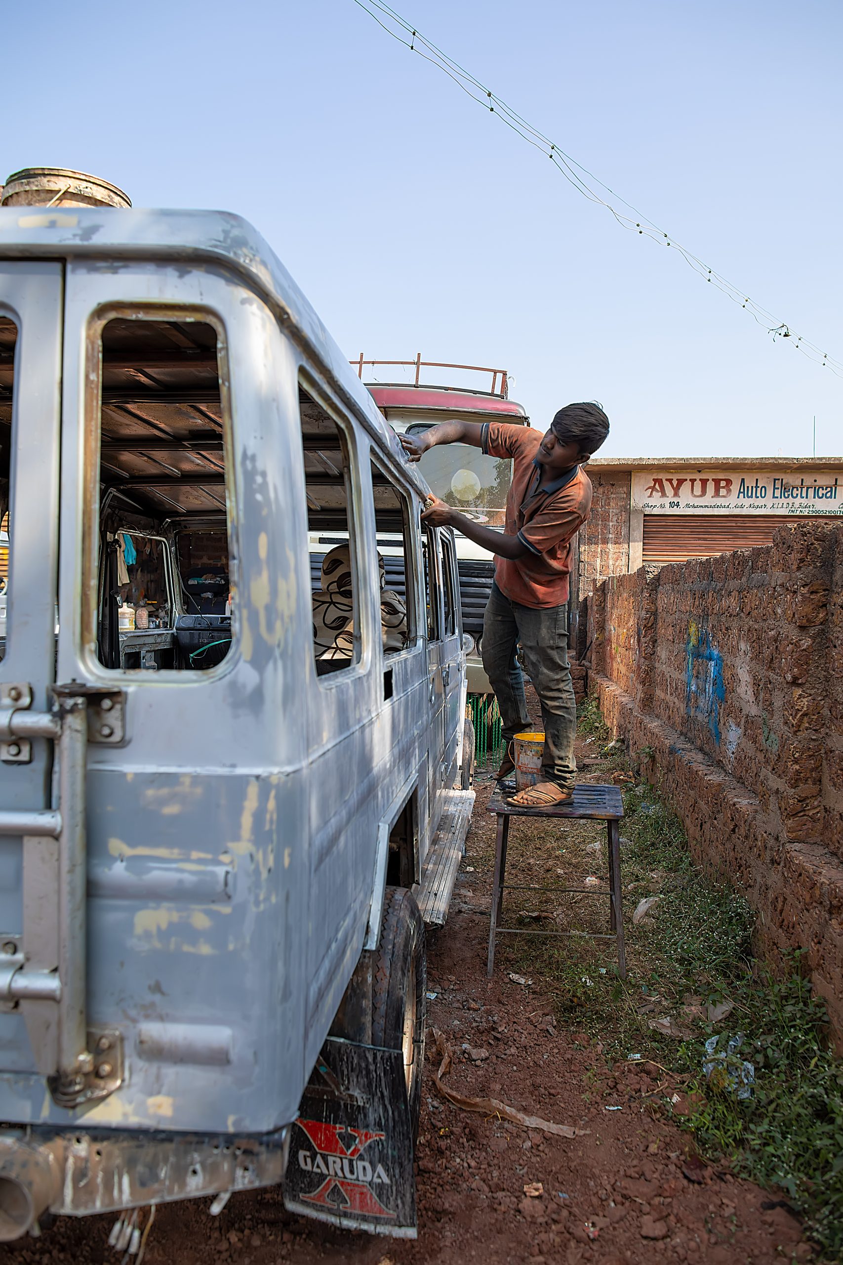 A mechanic working on an old car