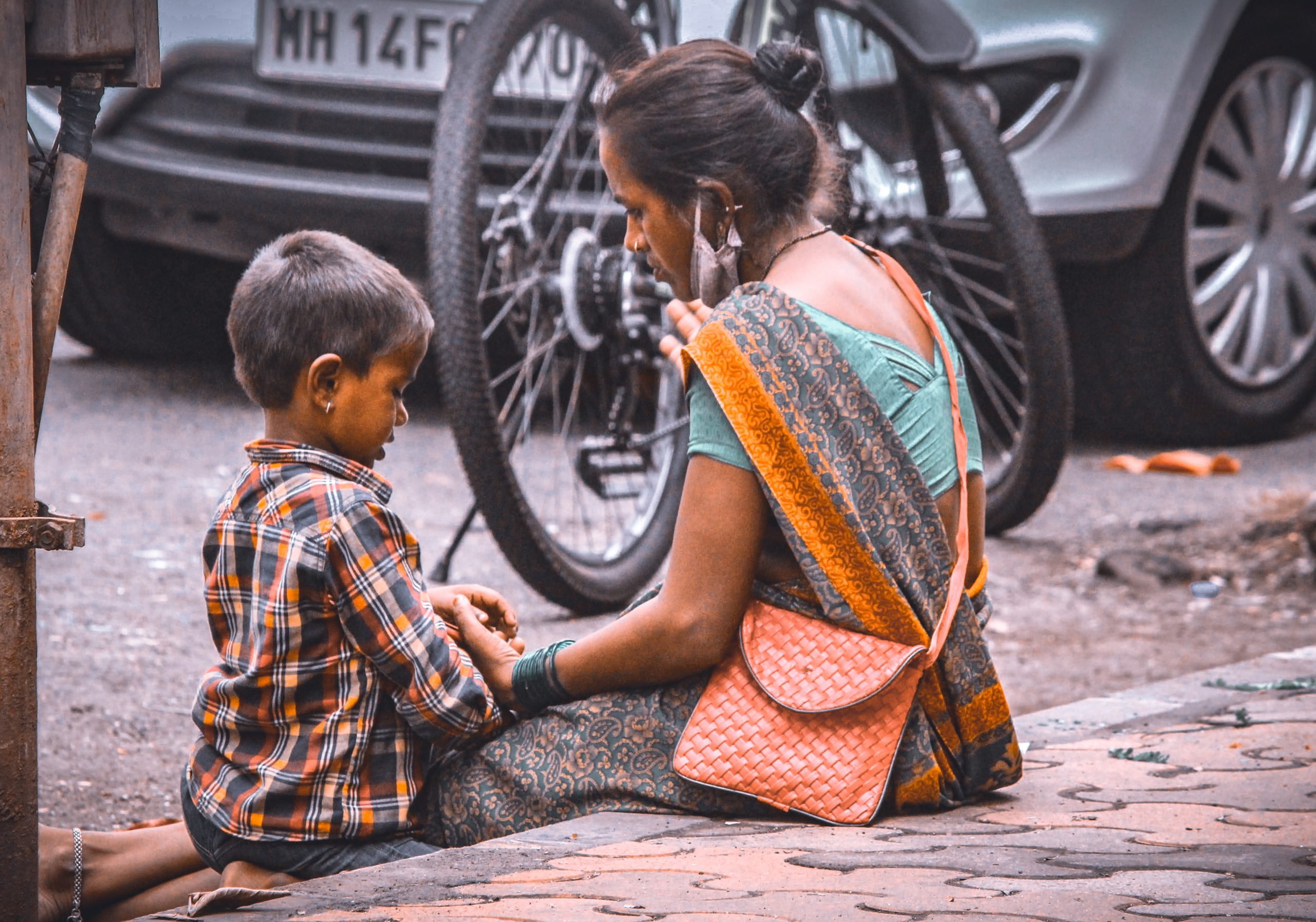 A mother with her kid on footpath