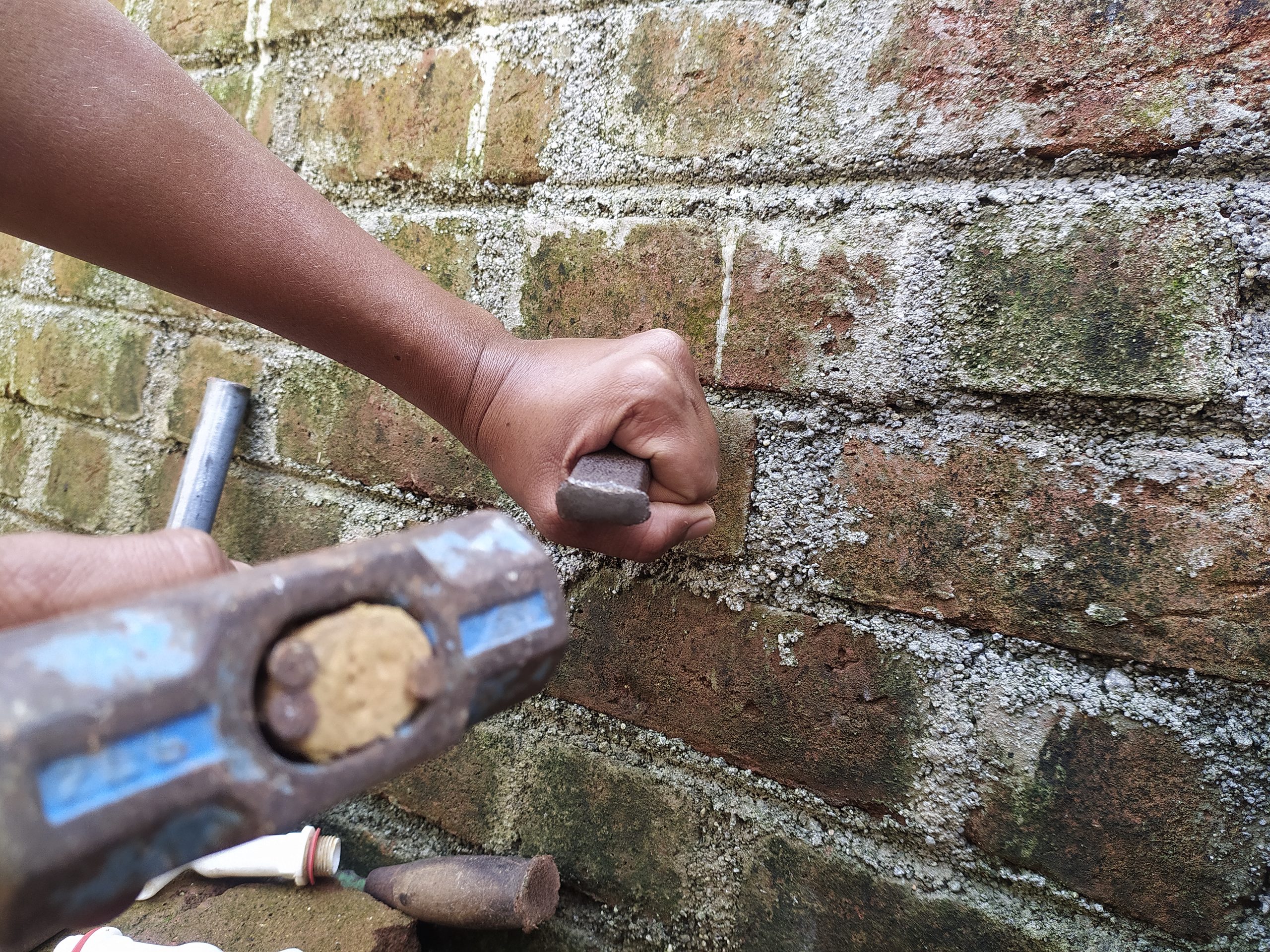 A plumber working on a wall
