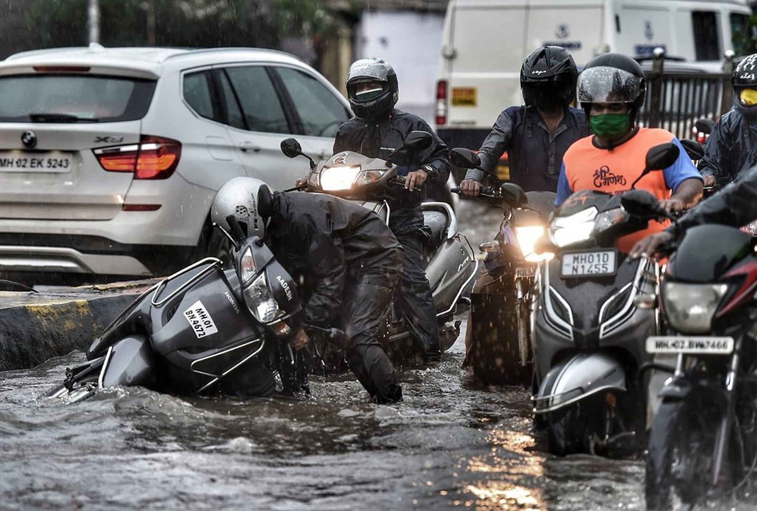 A scooter fall in a flooded road
