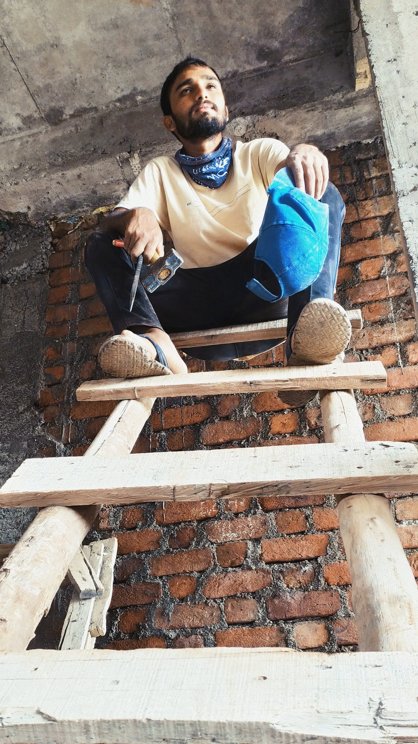 An electrician on a wooden stairs