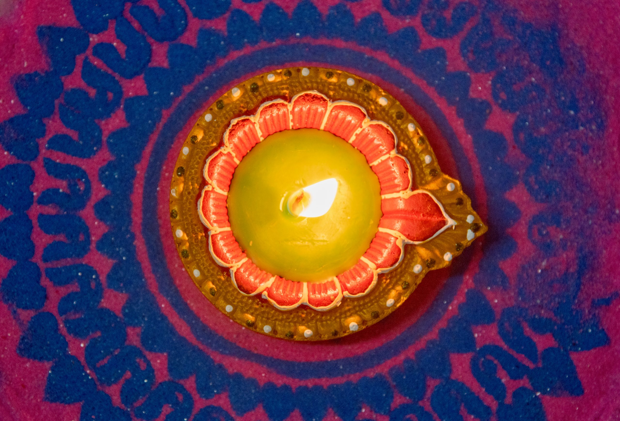 An oil lamp between a color design